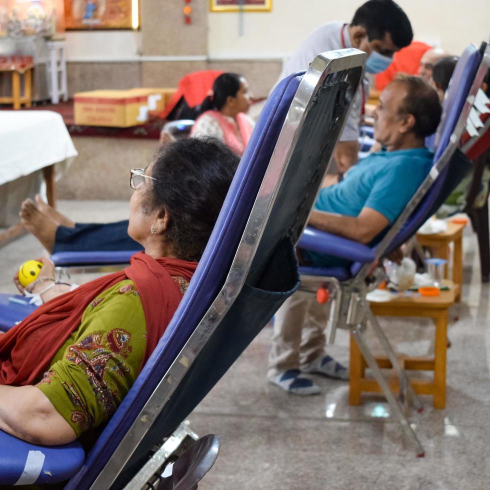 Delhi, India, June 19 2022 - Blood donor at Blood donation camp held at Balaji Temple, Vivek Vihar, Delhi, India, Image for World blood donor day on June 14 every year, Blood Donation Camp at Temple photo