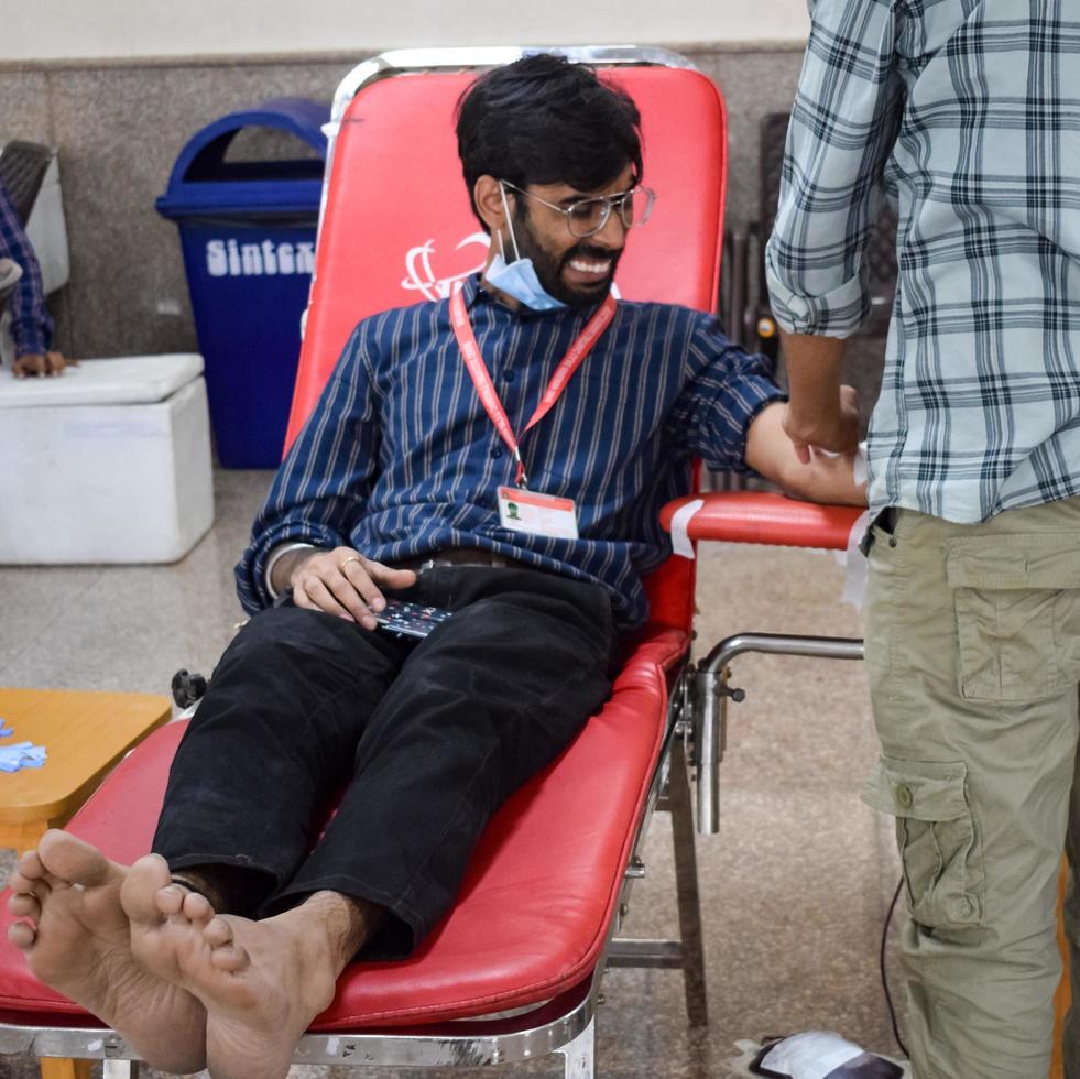 Delhi, India, June 19 2022 - Blood donor at Blood donation camp held at Balaji Temple, Vivek Vihar, Delhi, India, Image for World blood donor day on June 14 every year, Blood Donation Camp at Temple photo