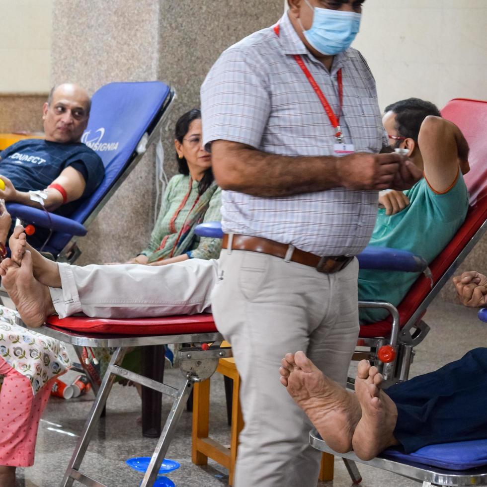 Delhi, India, June 19 2022 - Blood donor at Blood donation camp held at Balaji Temple, Vivek Vihar, Delhi, India, Image for World blood donor day on June 14 every year, Blood Donation Camp at Temple photo