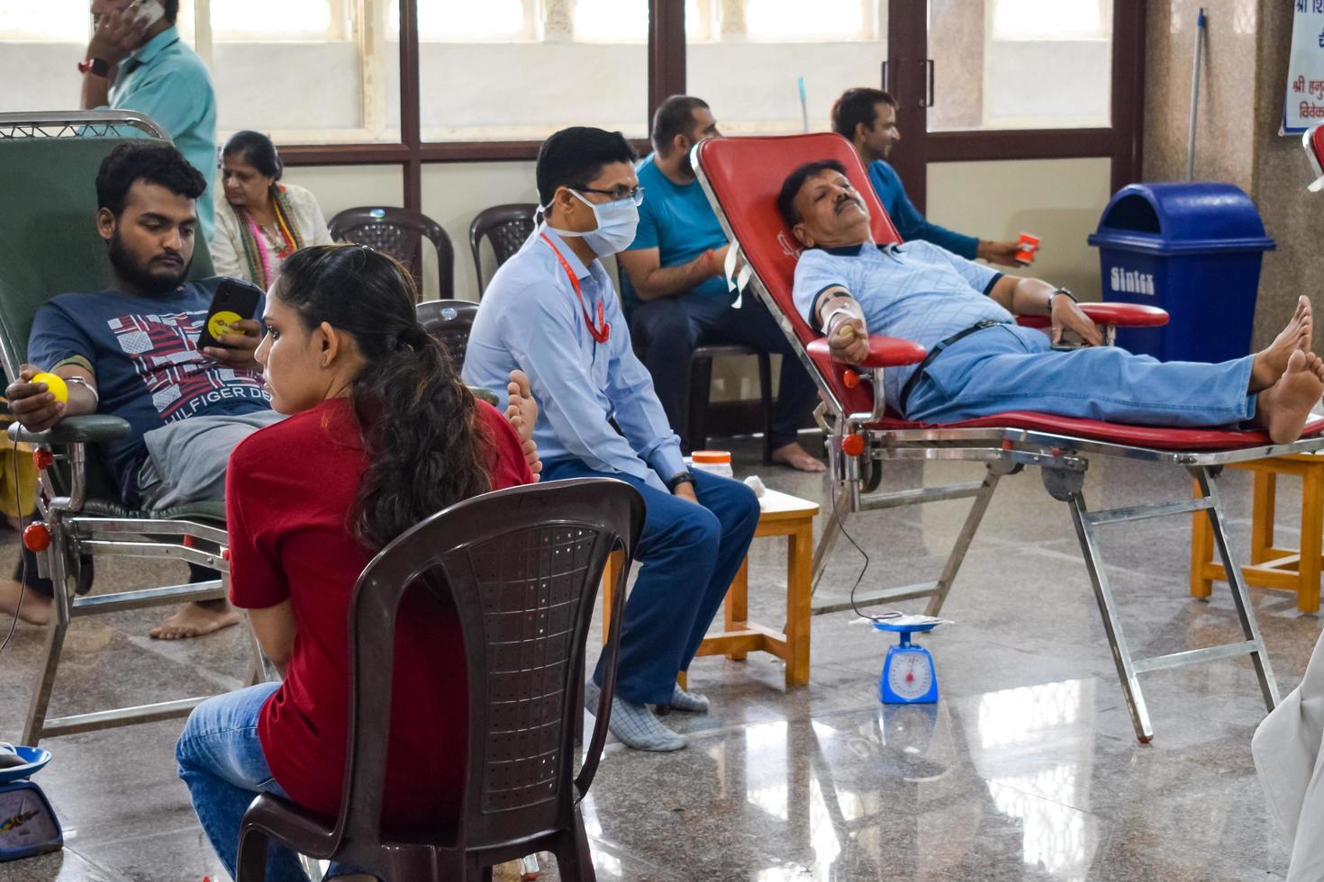 Delhi, India, June 19 2022 - Blood donor at Blood donation camp held at Balaji Temple, Vivek Vihar, Delhi, India, Image for World blood donor day on June 14 every year, Blood Donation Camp at Temple photo