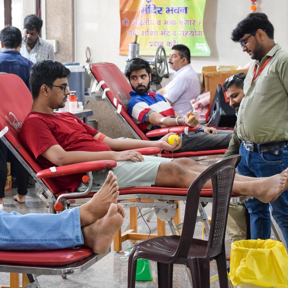 Delhi, India, June 19 2022 - Blood donor at Blood donation camp held at Balaji Temple, Vivek Vihar, Delhi, India, Image for World blood donor day on June 14 every year, Blood Donation Camp at Temple photo