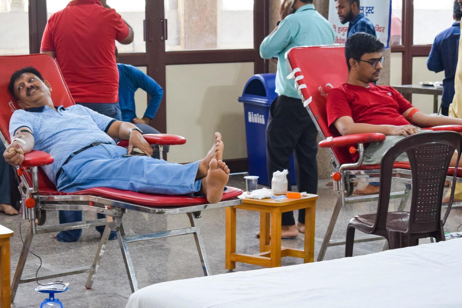 Delhi, India, June 19 2022 - Blood donor at Blood donation camp held at Balaji Temple, Vivek Vihar, Delhi, India, Image for World blood donor day on June 14 every year, Blood Donation Camp at Temple photo