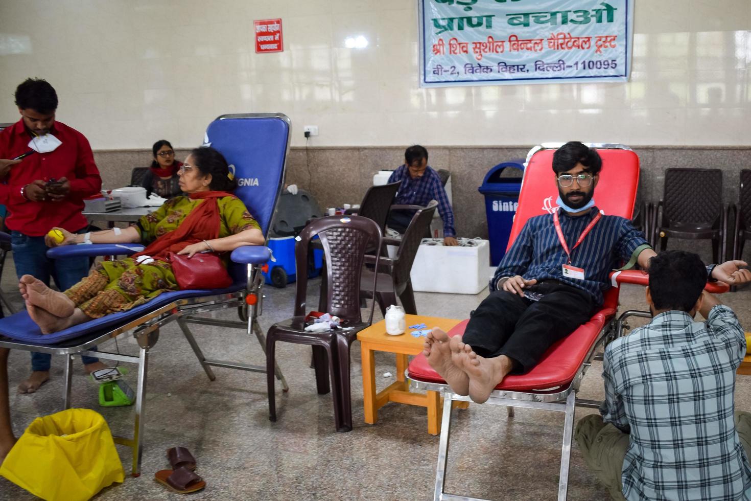 Delhi, India, June 19 2022 - Blood donor at Blood donation camp held at Balaji Temple, Vivek Vihar, Delhi, India, Image for World blood donor day on June 14 every year, Blood Donation Camp at Temple photo