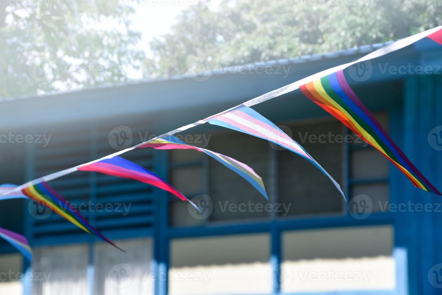 Lgbtq flags were hung on wire to decorate outside balcony of restaurant, soft and selective focus, concept for LGBTQ plus gender celebrations in pride month around the world. photo