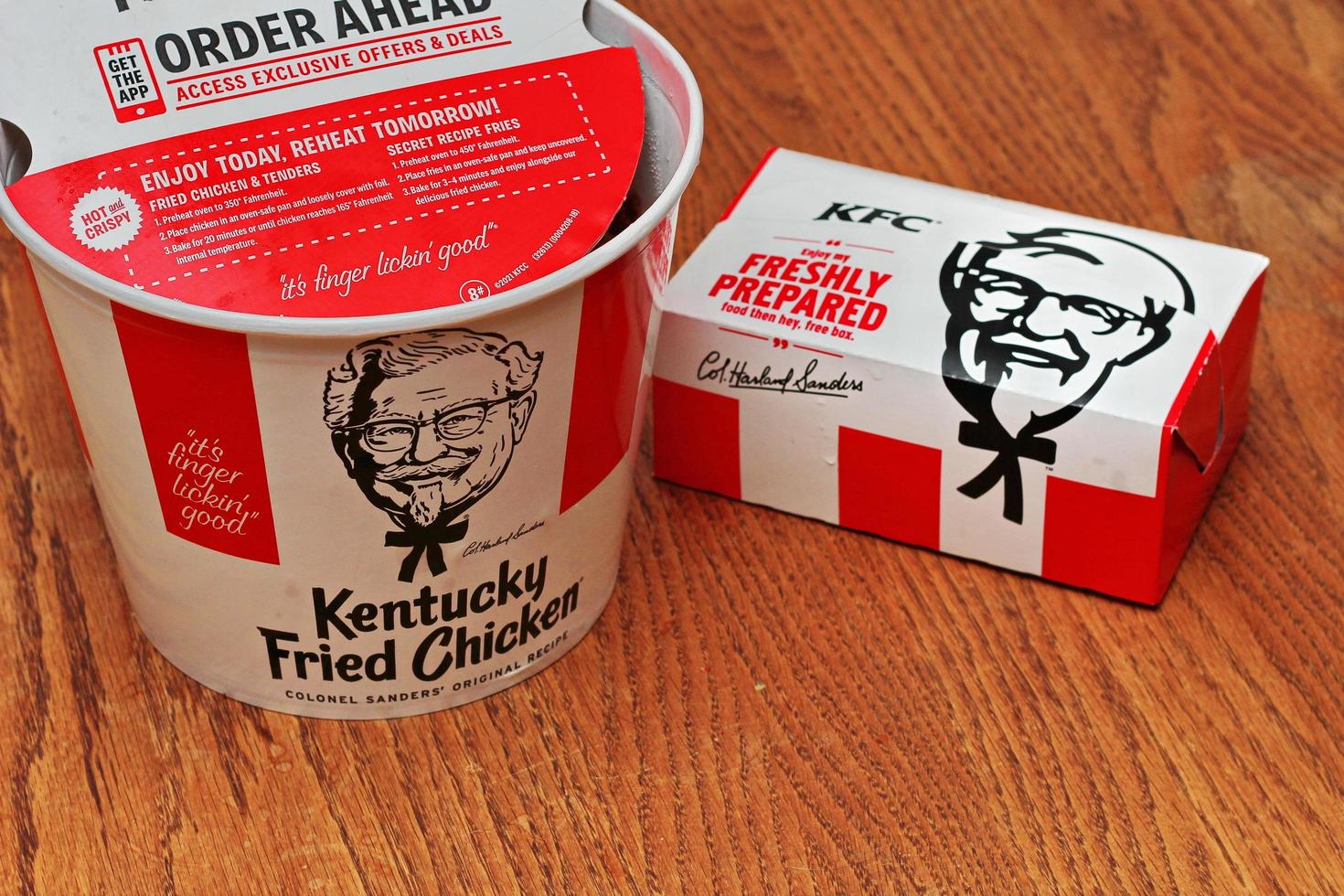 Washington USA  June 01 2022  American style fried chicken Kentucky Fly Chicken or KFC put in a bucket and put in a box to take home. KFC fried chicken in a package, a bucket photo