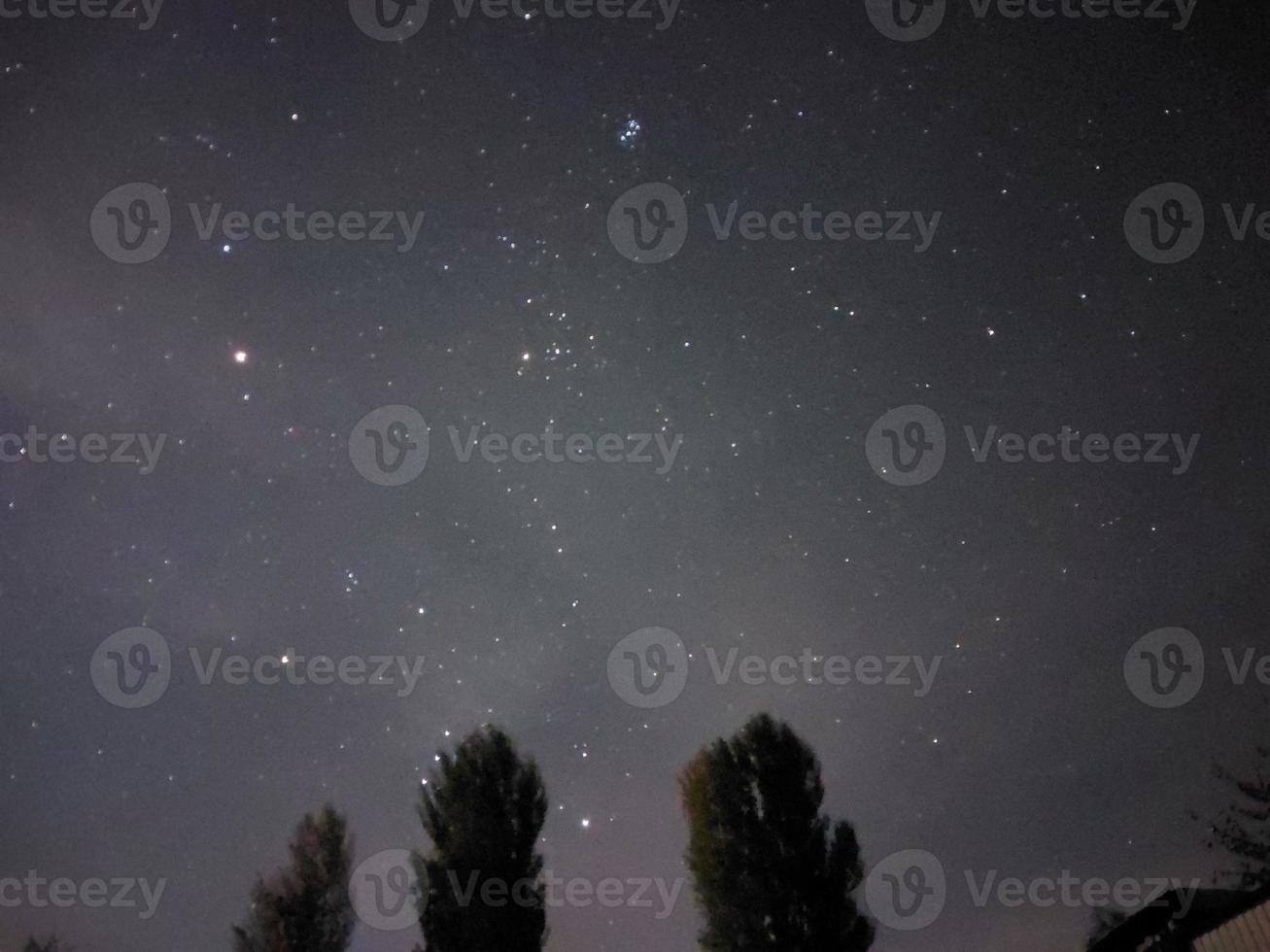 Bright night starry sky in the village photo