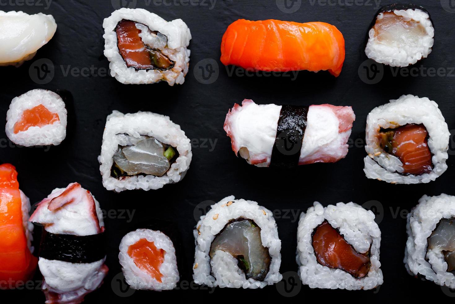 japanese sushi food. Maki ands rolls with tuna, salmon, shrimp, crab and avocado. Top view of assorted sushi. photo