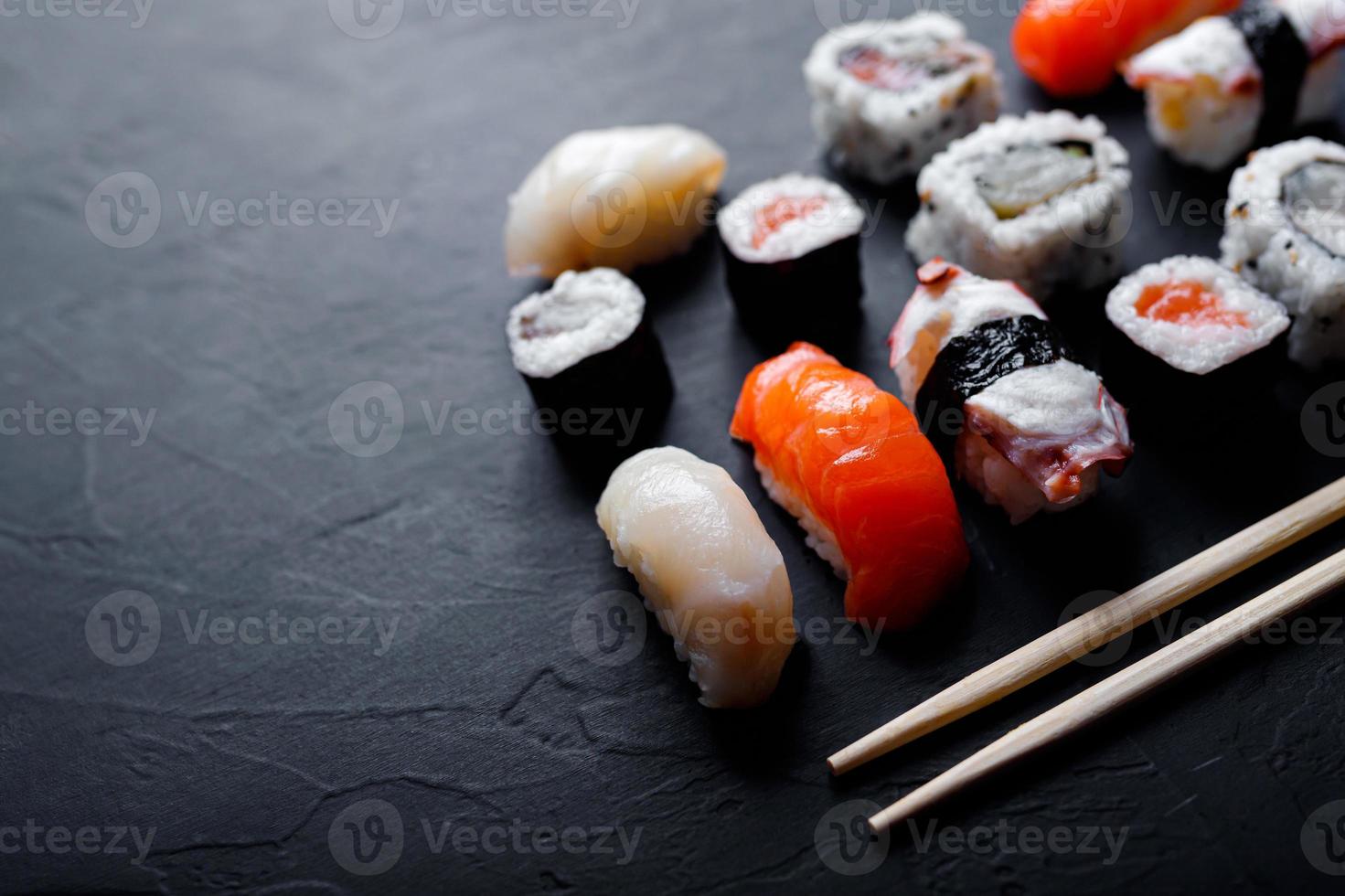 japanese sushi food. Maki ands rolls with tuna, salmon, shrimp, crab and avocado. Top view of assorted sushi. photo