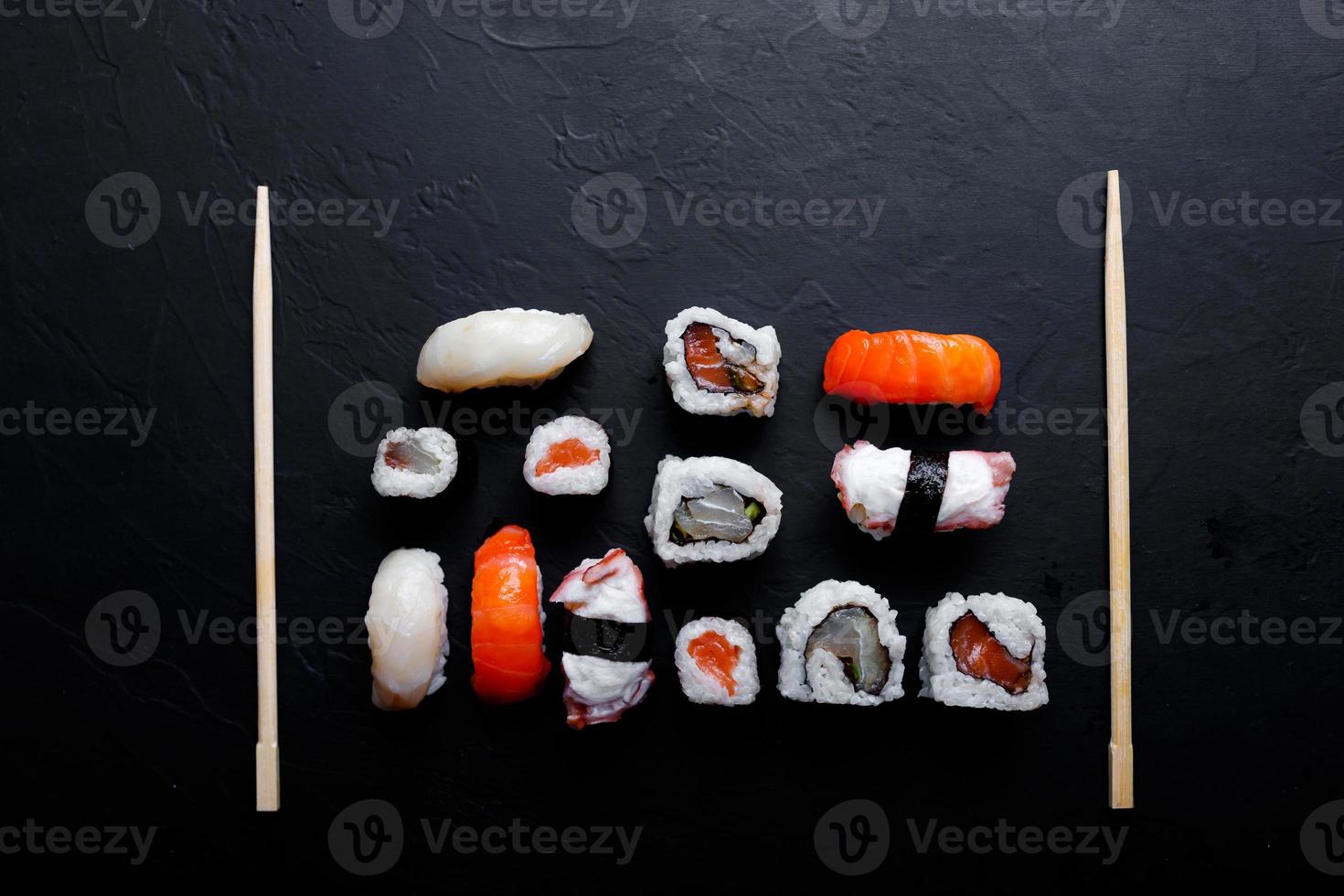japanese sushi food. Maki ands rolls with tuna, salmon, shrimp, crab and avocado. Top view of assorted sushi. photo