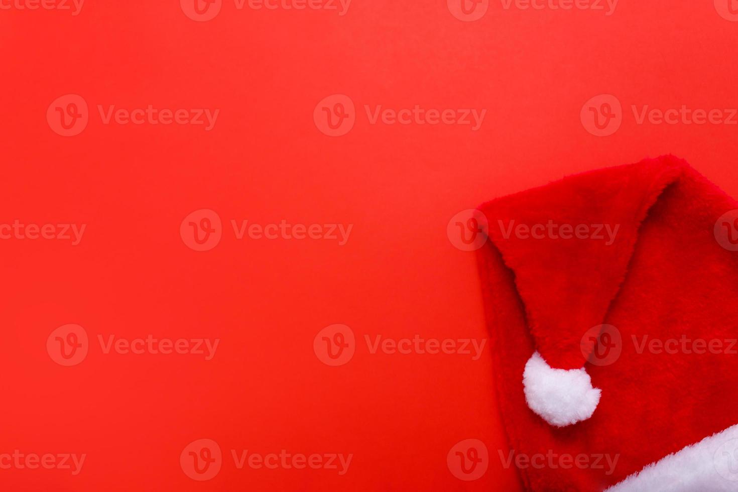 Santa hat on red christmas background with copy space for text. photo
