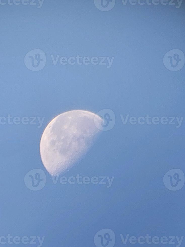 Morning moon in the blue sky photo