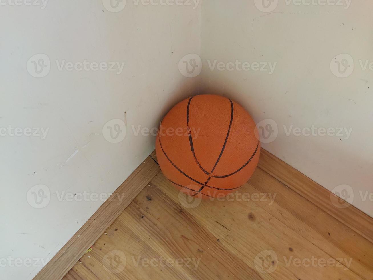 The basketball is in the corner of the room photo