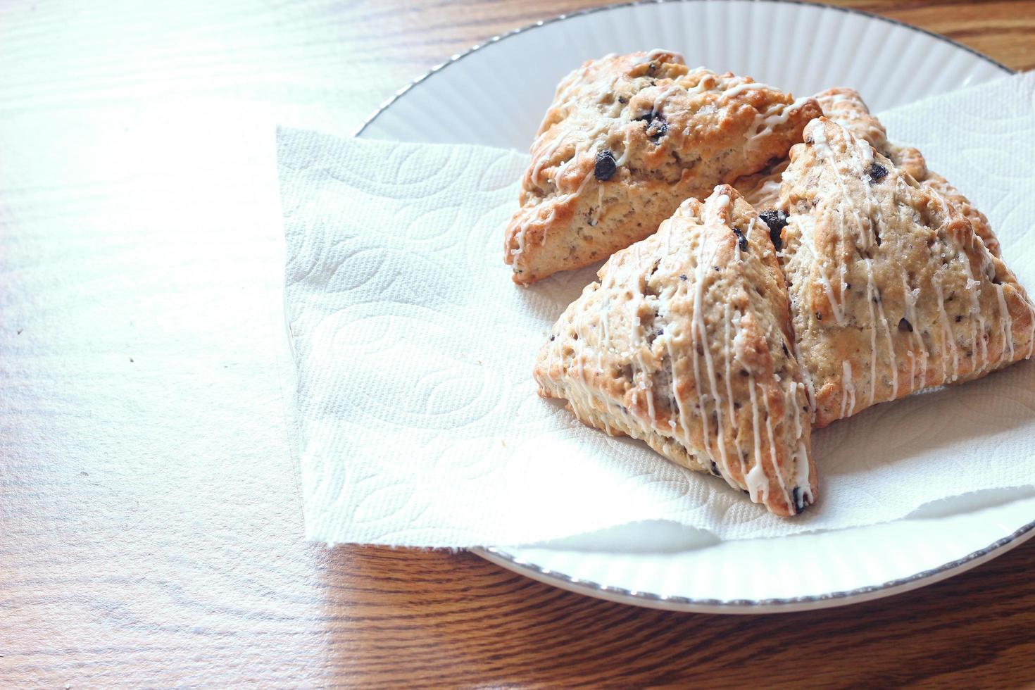 blue berry scones served in white plates photo