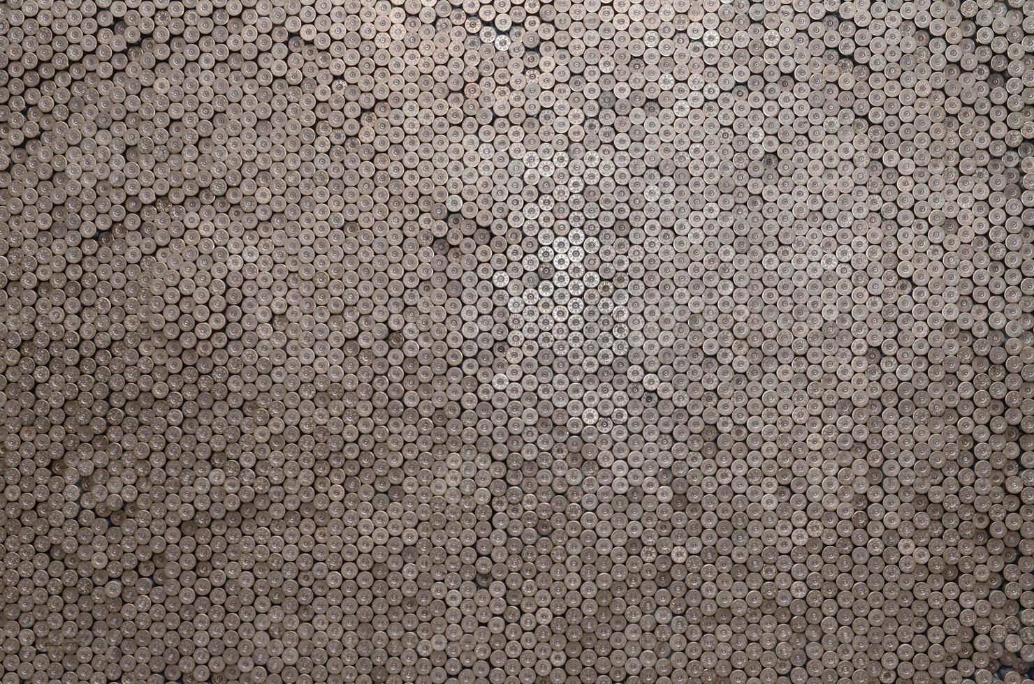 Pattern of 12 gauge cartridges for shotgun bullets. Shells for hunting rifle close up. Backdrop for shooting range or ammunition trade concepts photo