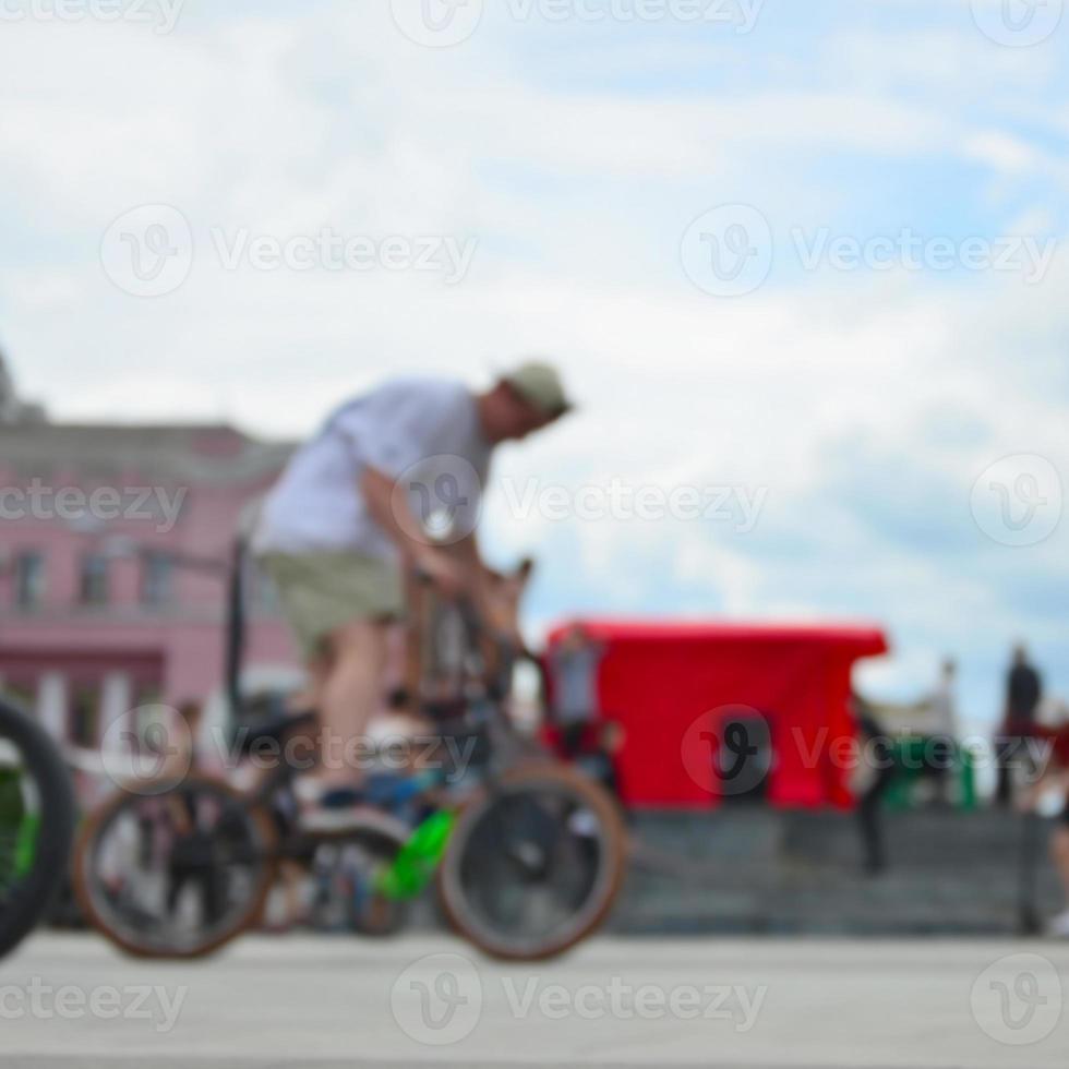 Defocused image of a lot of people with bmx bikes. Meeting of fans of extreme sports photo