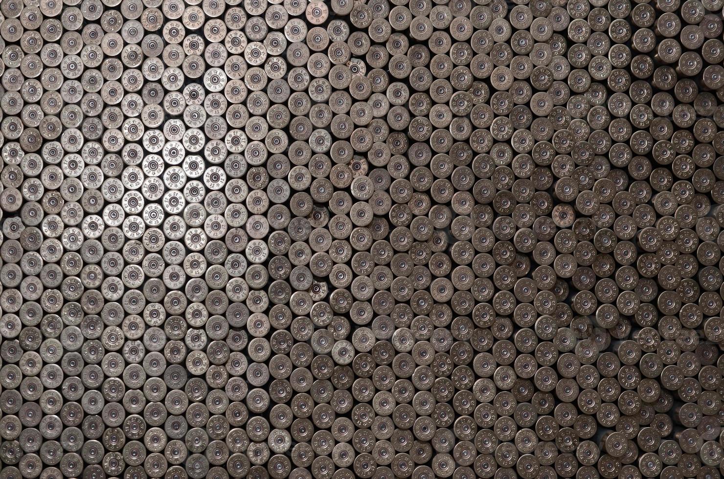 Pattern of 12 gauge cartridges for shotgun bullets. Shells for hunting rifle close up. Backdrop for shooting range or ammunition trade concepts photo