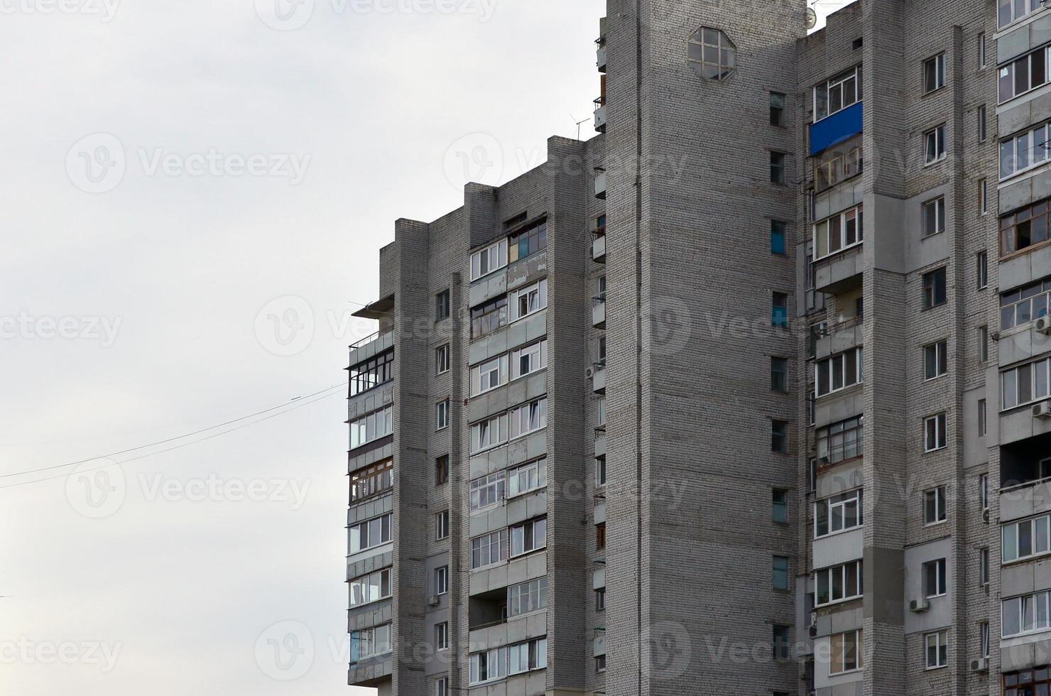 Old multi-storey apartment house in a poorly-developed region of Ukraine or Russia photo