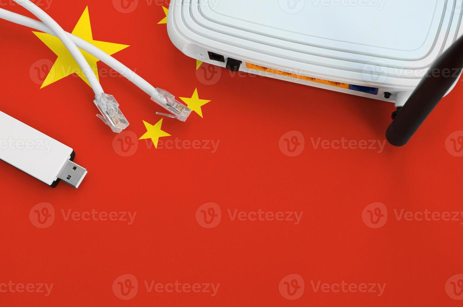 China flag depicted on table with internet rj45 cable, wireless usb wifi adapter and router. Internet connection concept photo