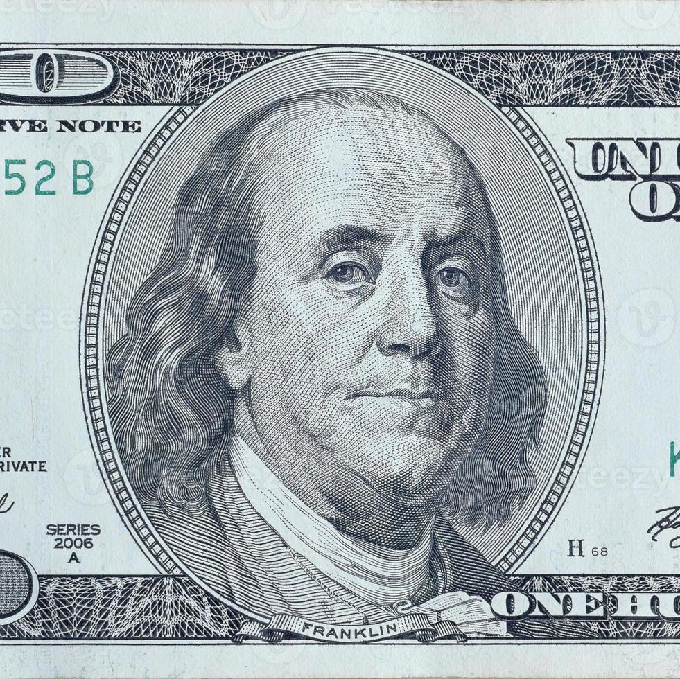 Portrait of US president Benjamin Franklin on 100 dollars banknote closeup macro fragment. United states hundred dollars money bill photo