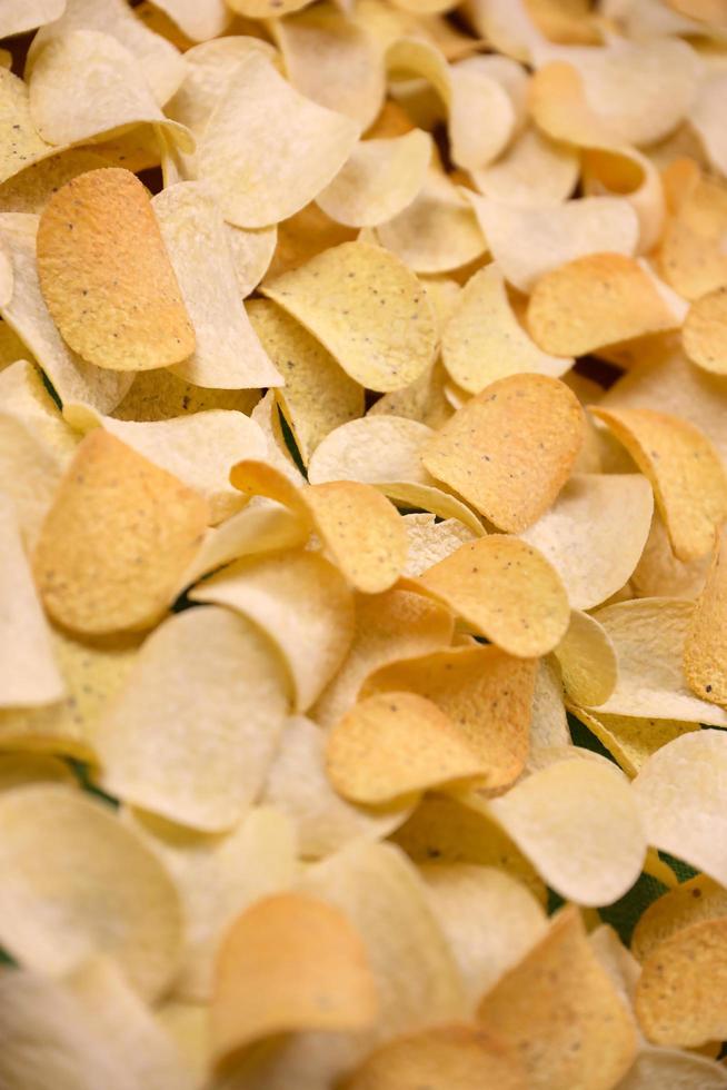 KHARKIV, UKRAINE - MAY 02, 2021 Many orange Pringles potato snack chips. Pringles is a brand of potato snack chips owned by Kellogg Company photo
