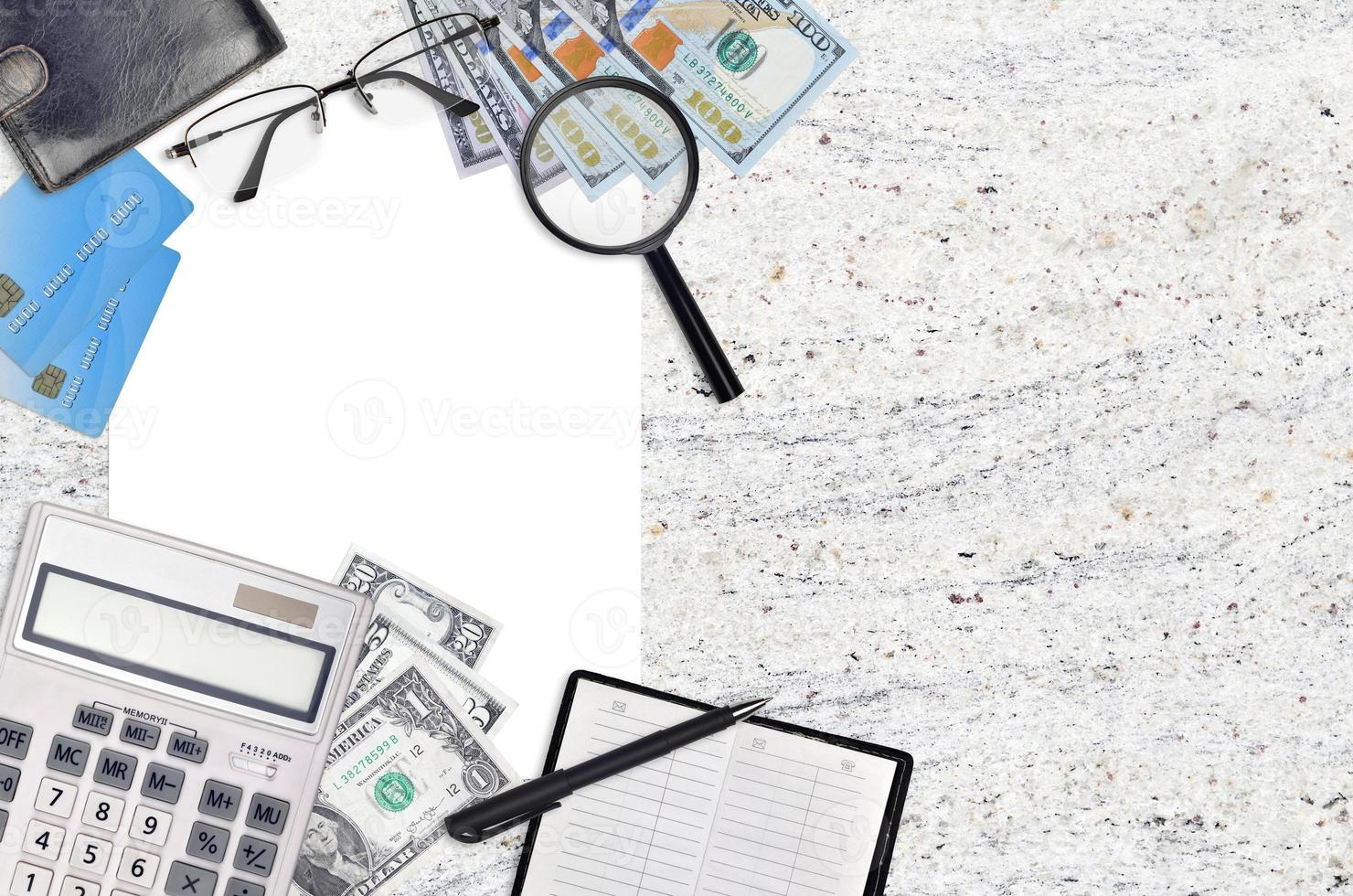 Office flat lay composition with calculator, address book and other office items on brown wooden table background with top view. Accountant paperwork photo