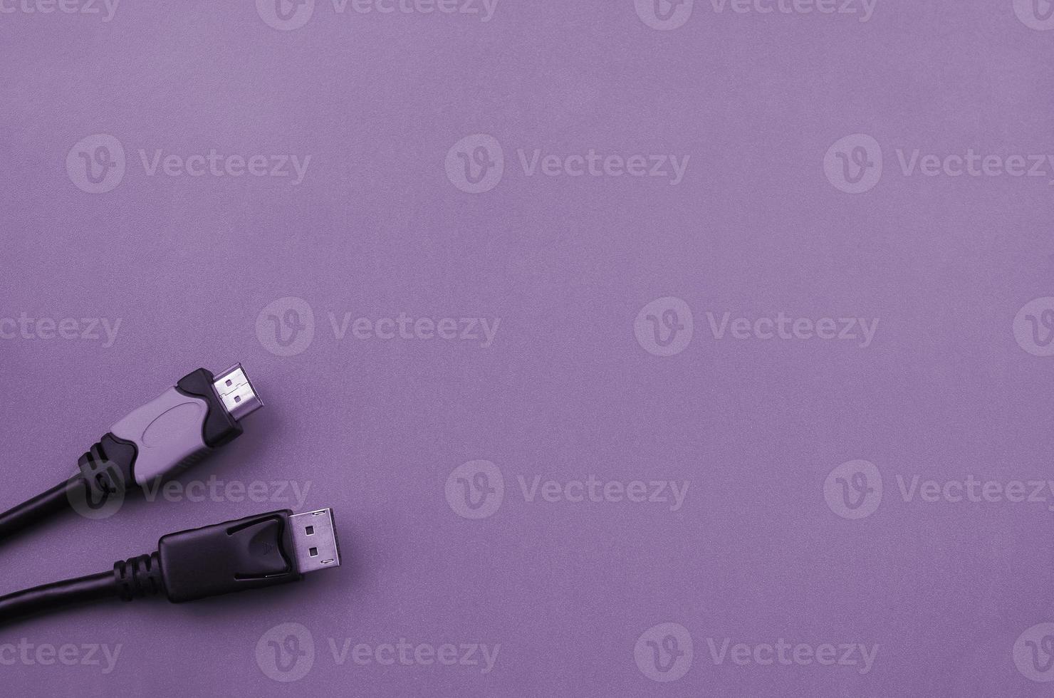 Audio video HDMI computer cable plug and 20-pin male DisplayPort gold plated connector for a flawless connection on purple backdrop photo