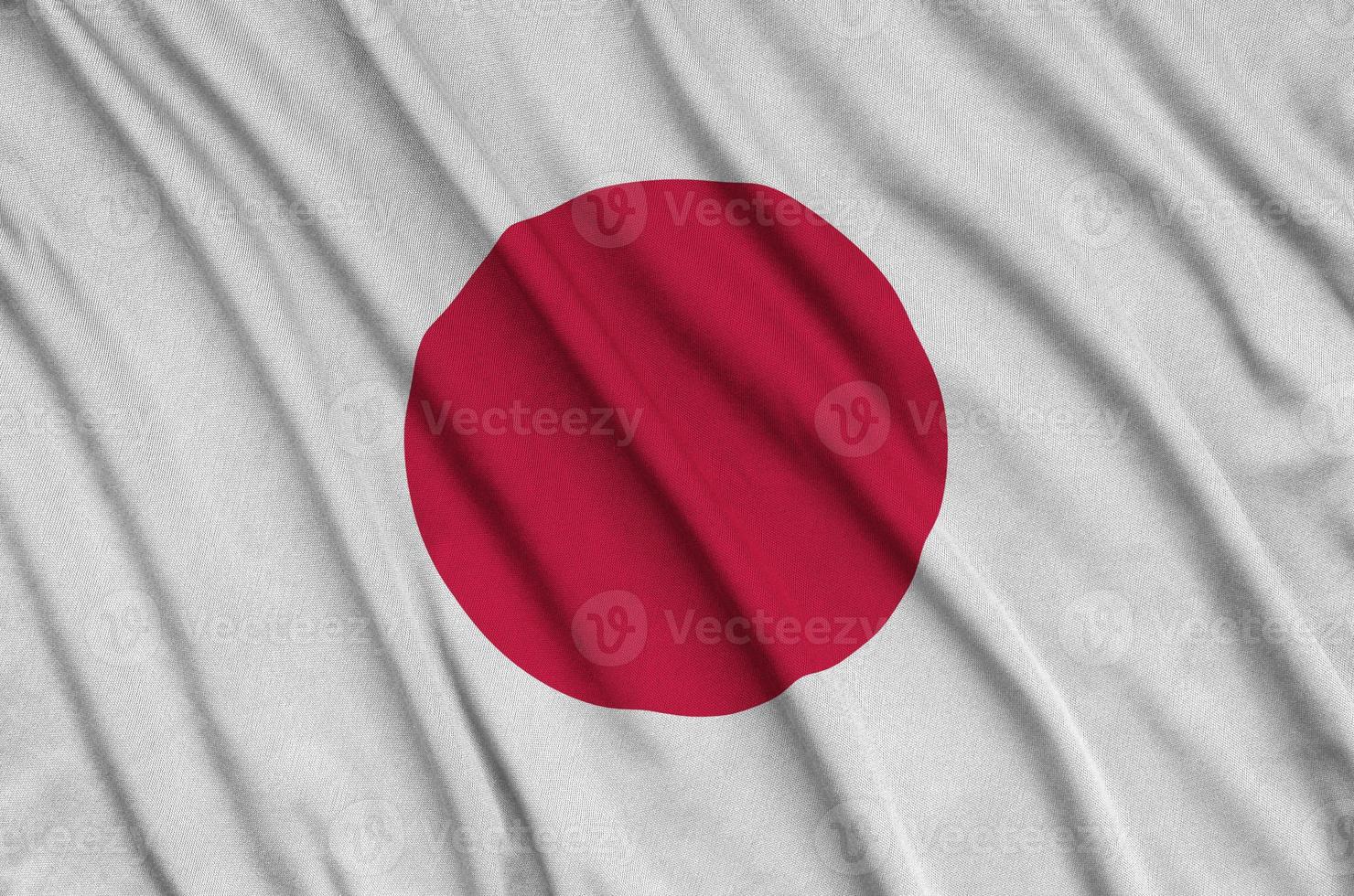 Japan flag  is depicted on a sports cloth fabric with many folds. Sport team banner photo