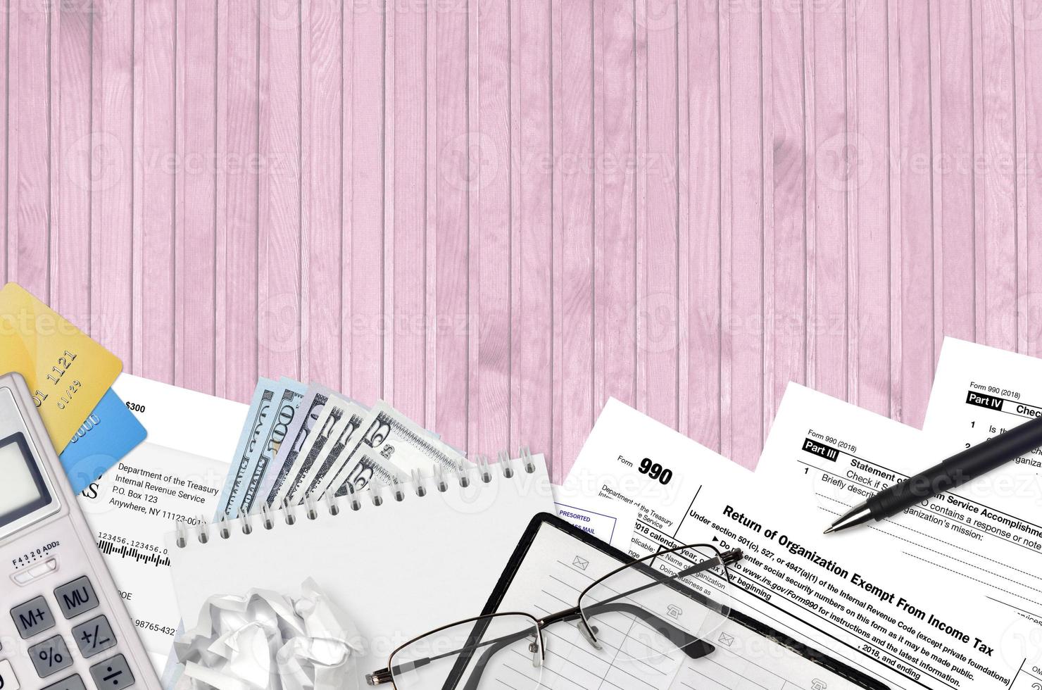 IRS form 990 Return of organization exempt from income tax lies on flat lay office table and ready to fill. U.S. Internal revenue services paperwork concept. Time to pay taxes photo
