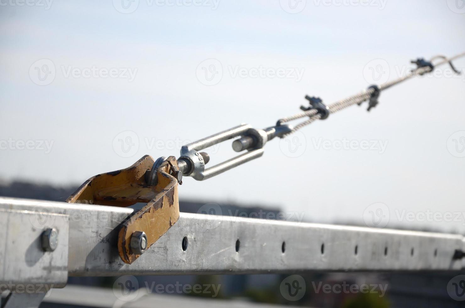 Rope lockers in rear beam of suspended wire rope platform for facade works on high multistorey buildings. Rope lockers blocks kink for safety platform usage photo