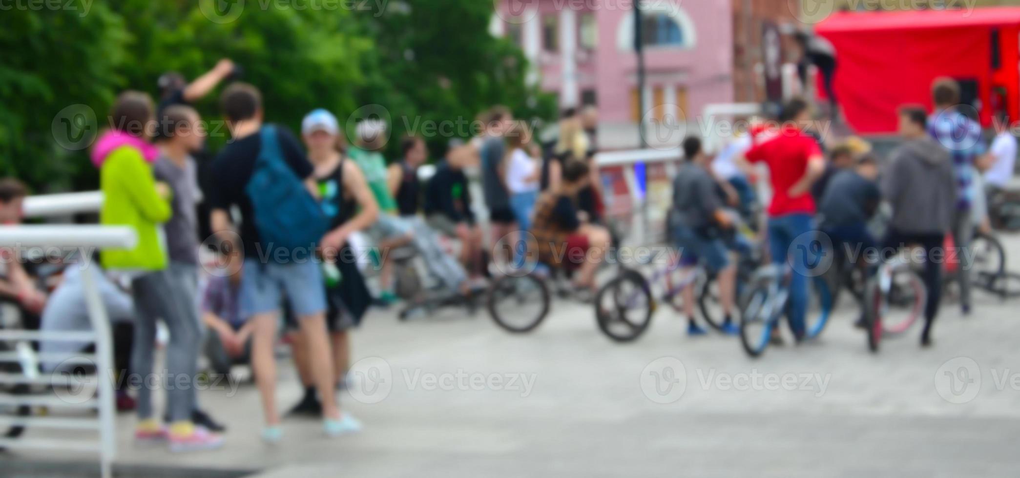 Defocused image of a lot of people with bmx bikes. Meeting of fans of extreme sports photo