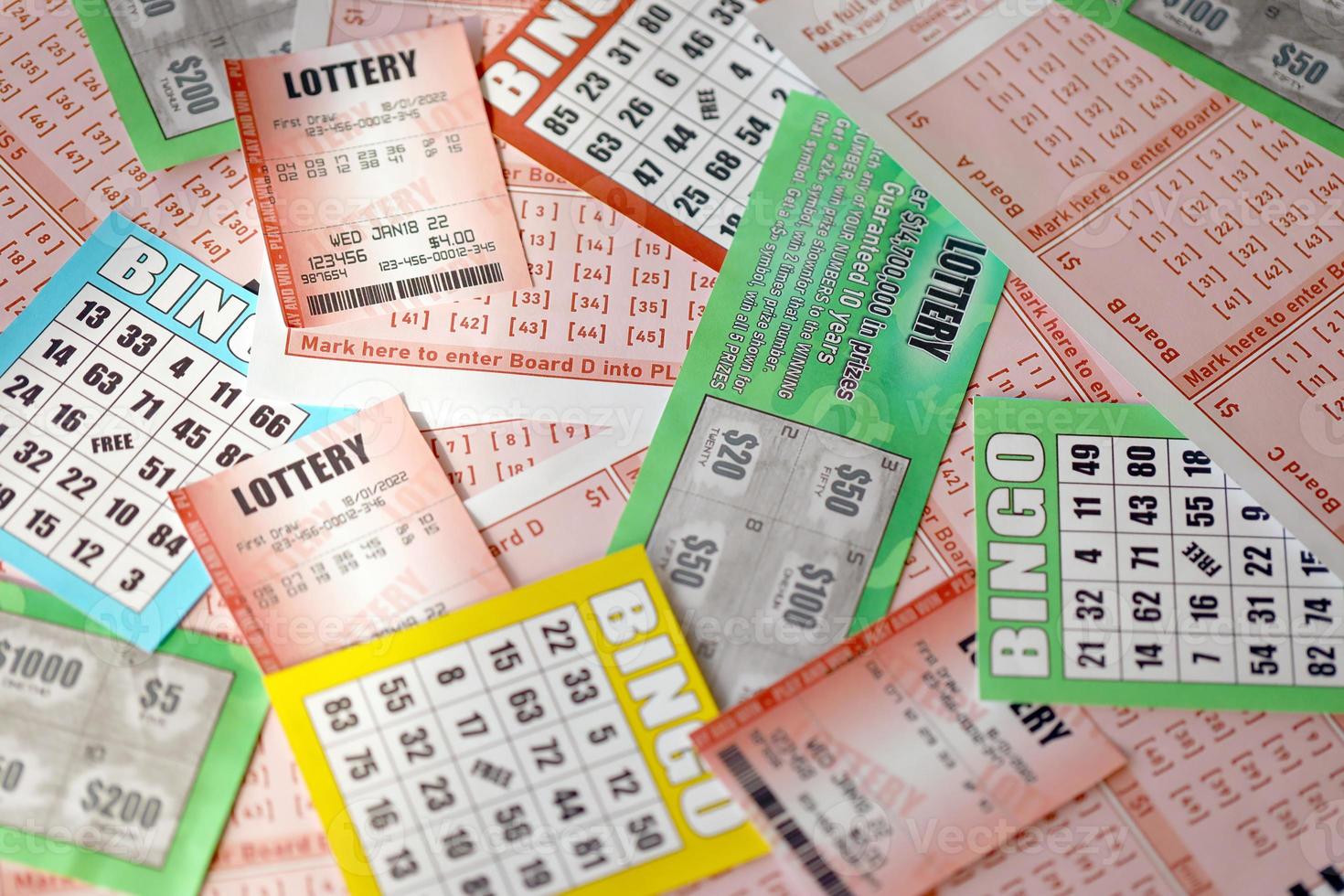 Many used lottery tickets, bills with numbers and bingo playing boards in big pile. Gambling and lottery paper stuff photo