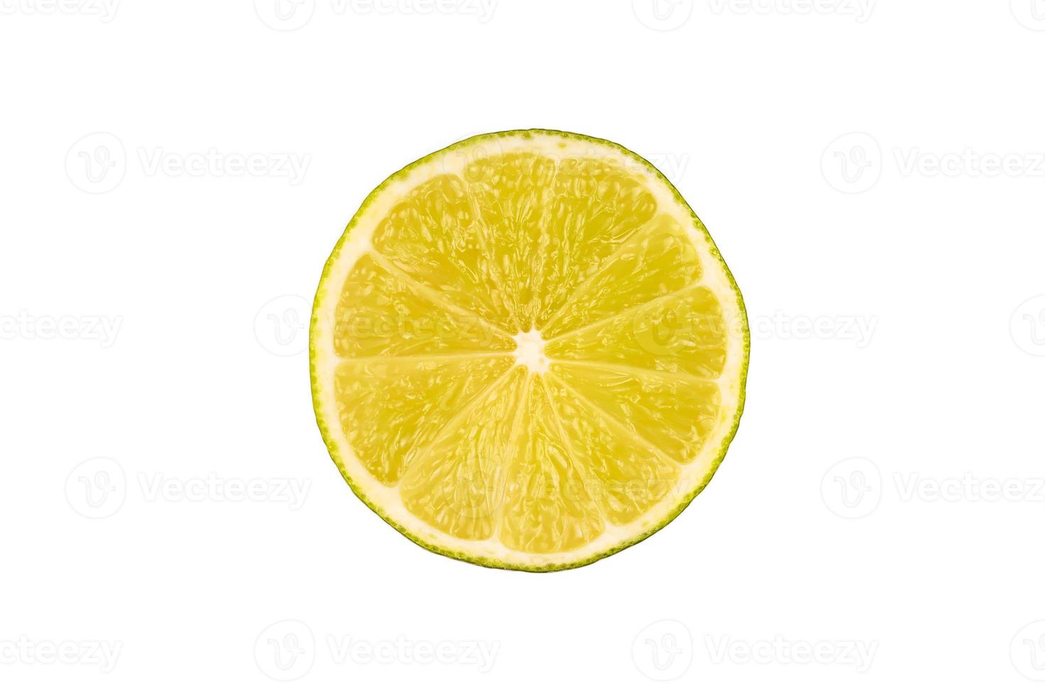 Slice of green lime on light white background. Fresh fruit with copy space photo