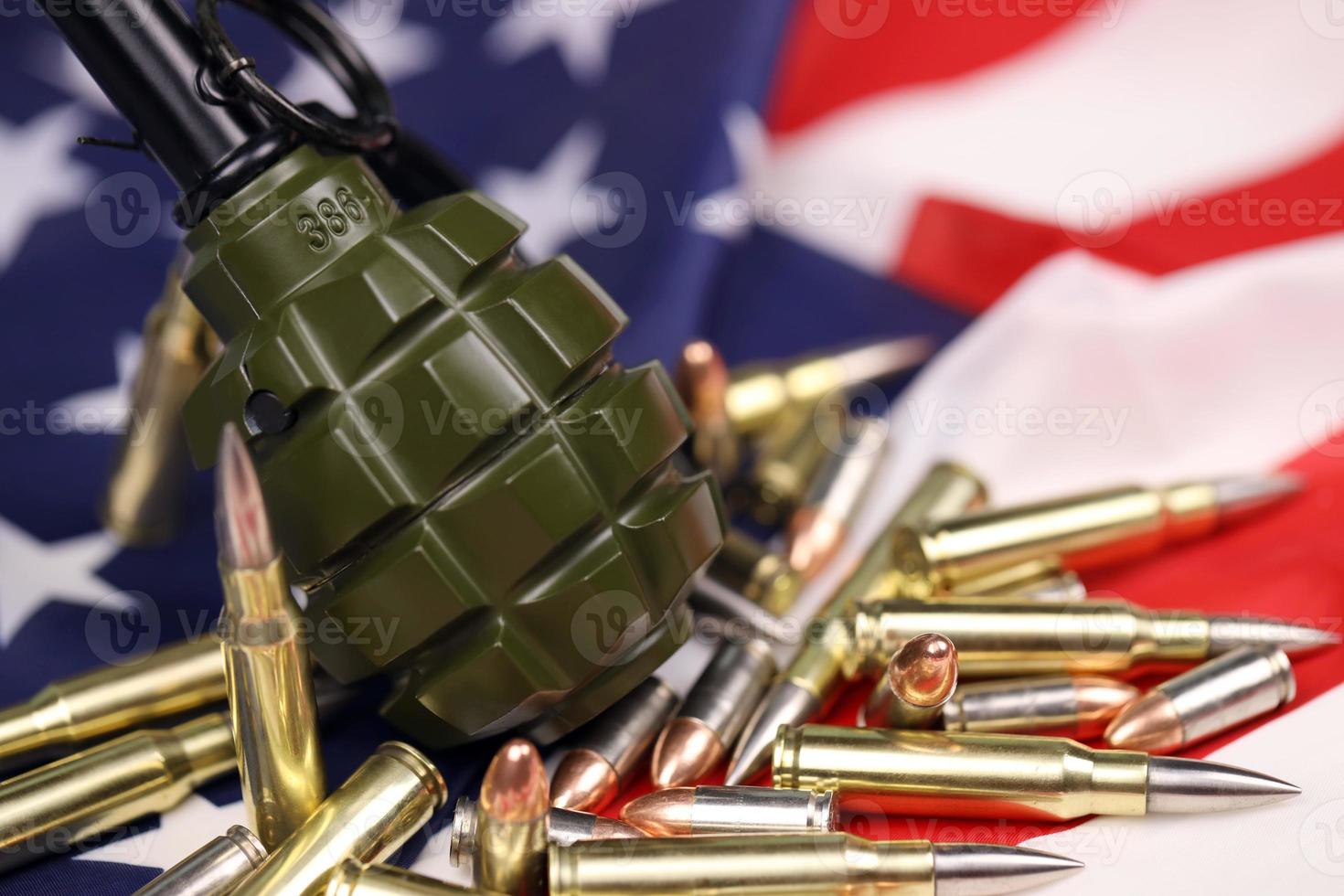 F1 frag grenade and many yellow bullets and cartridges on United States flag. Concept of gun trafficking on USA territory or spec ops photo