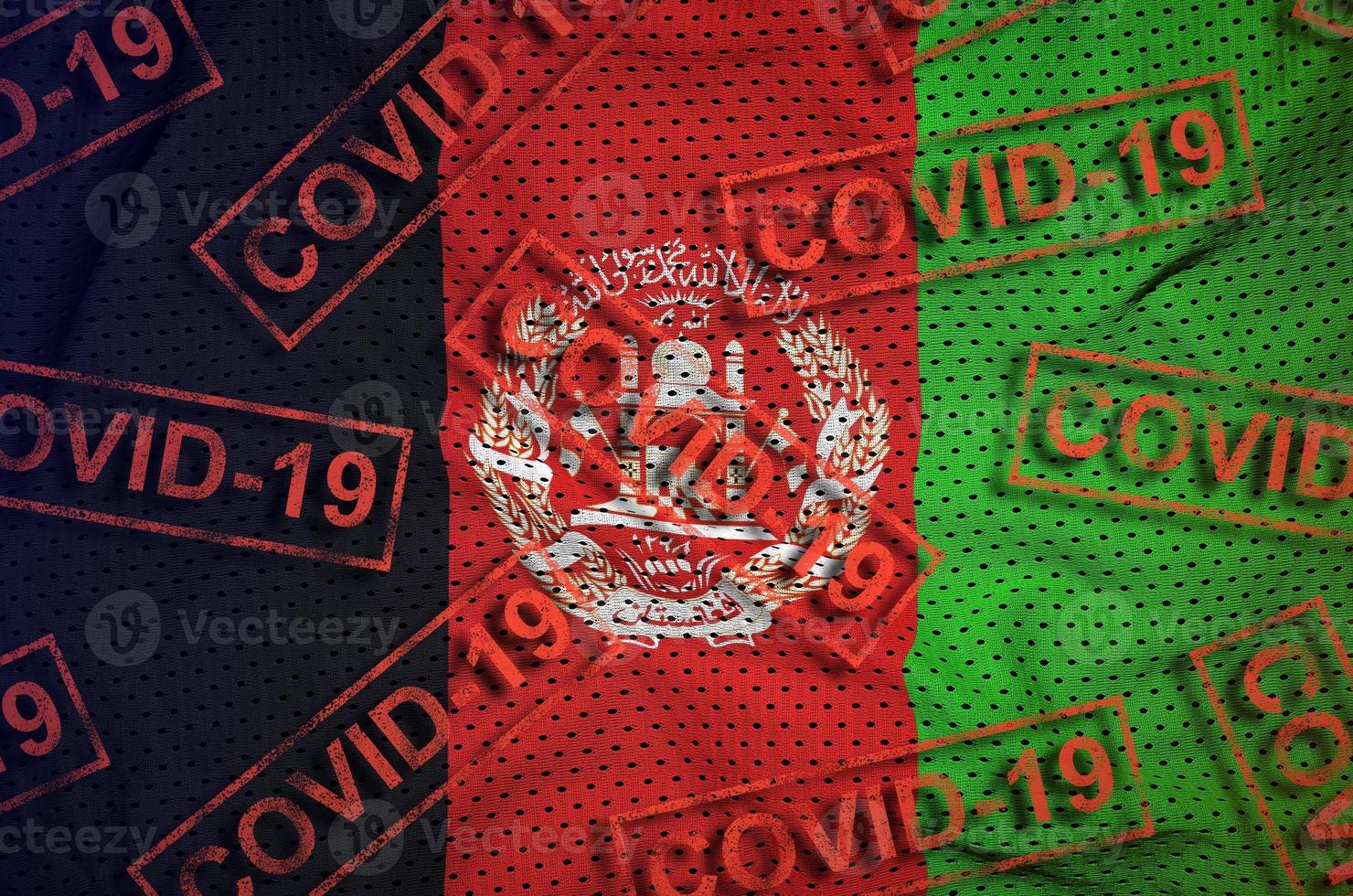 Afghanistan flag and many red Covid-19 stamps. Coronavirus or 2019-nCov virus concept photo