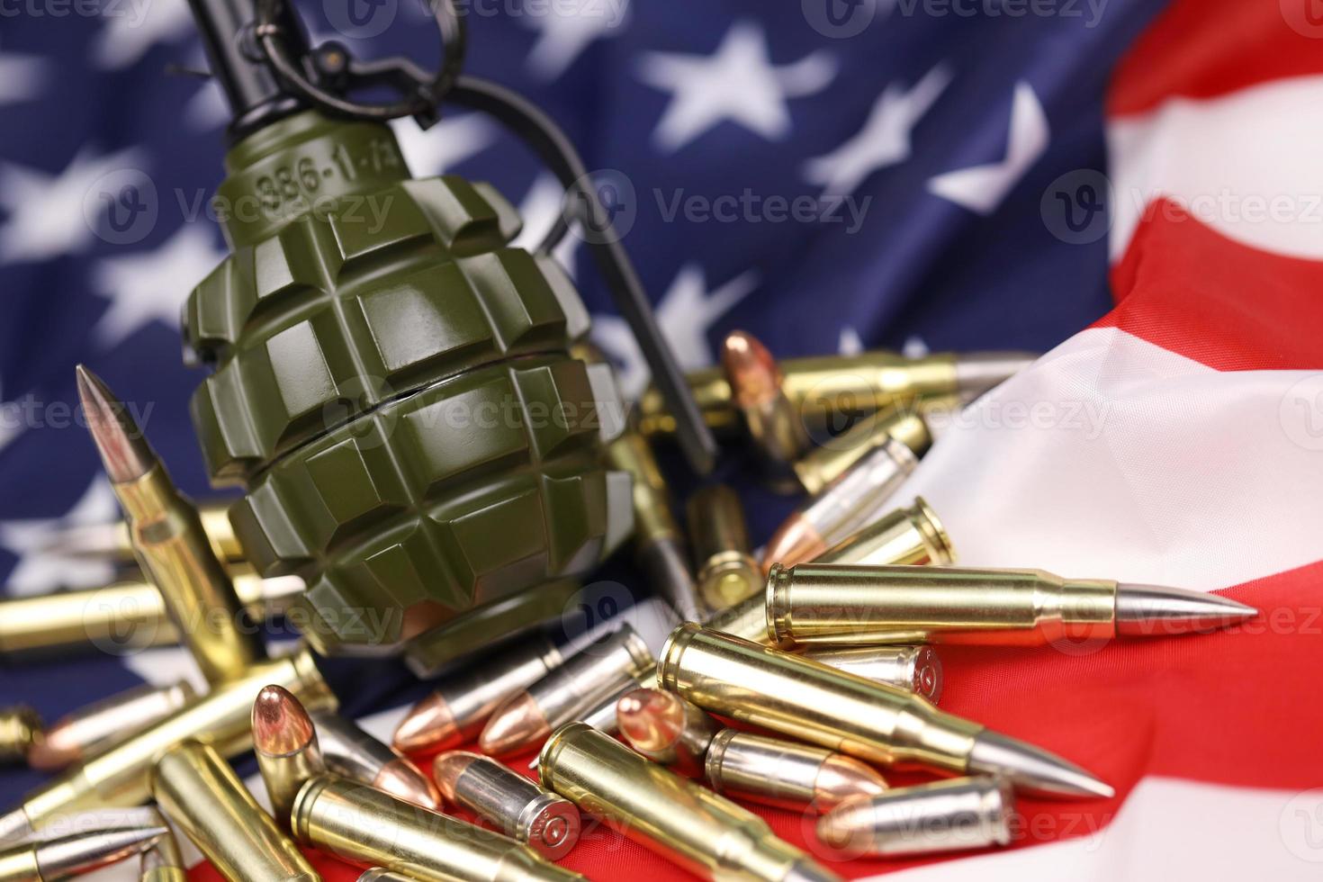 F1 frag grenade and many yellow bullets and cartridges on United States flag. Concept of gun trafficking on USA territory or spec ops photo