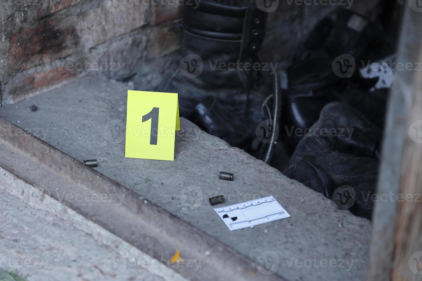 Evidence with yellow CSI marker for evidence numbering on the residental backyard in evening. Crime scene investigation concept photo
