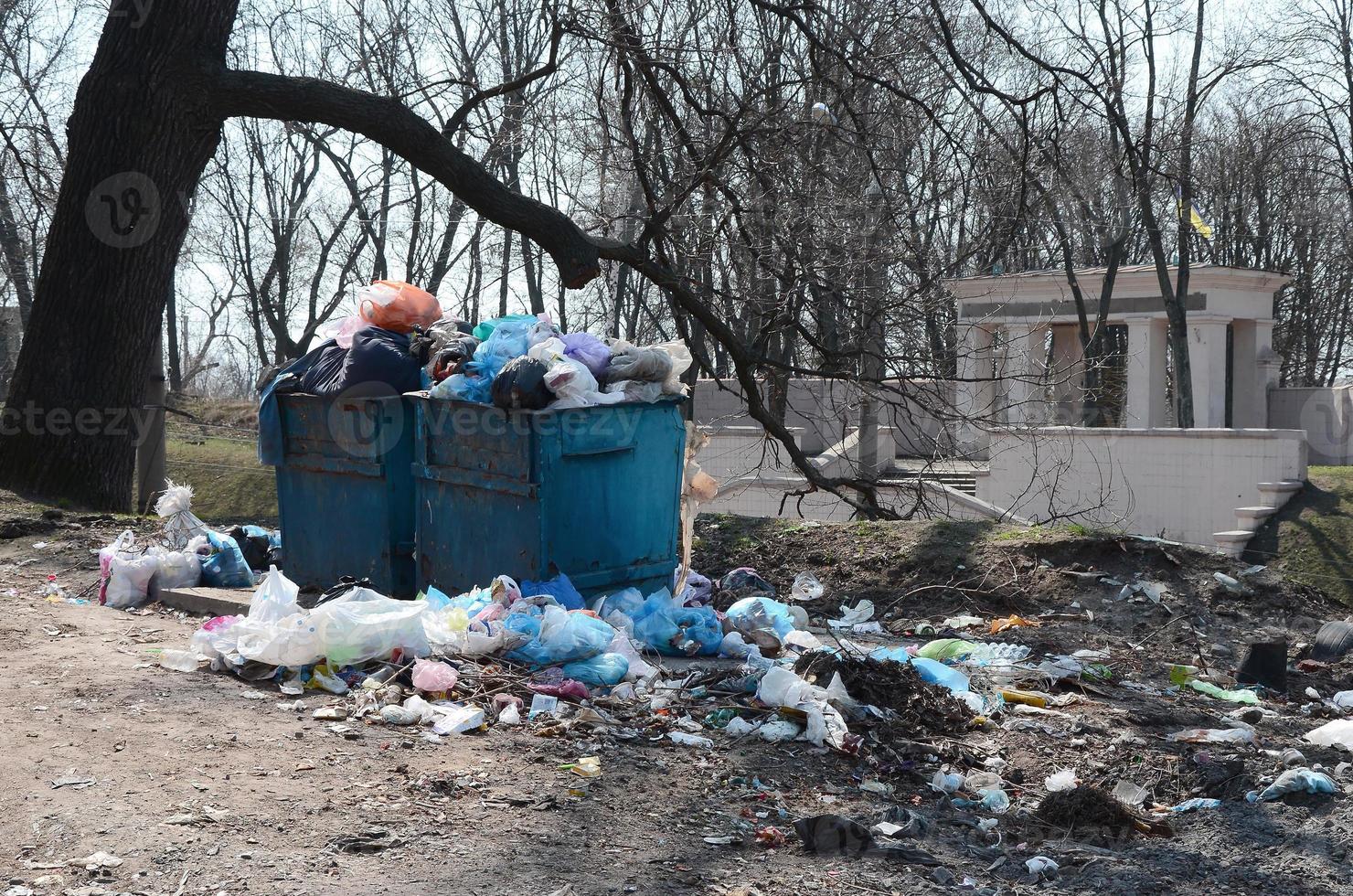 Garbage can is packed with garbage and waste. Untimely removal of garbage in populated areas photo