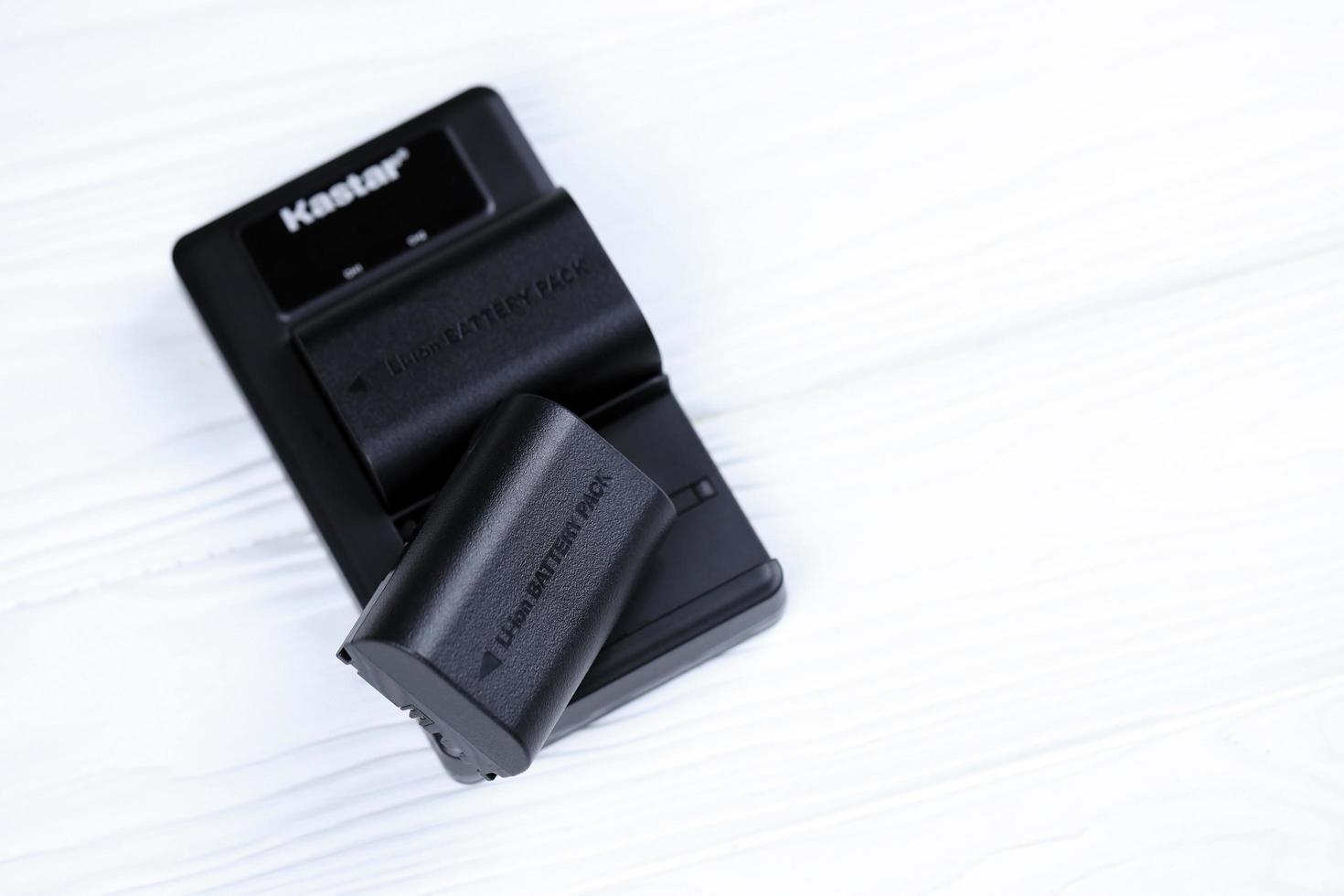 KHARKOV, UKRAINE - MARCH 14, 2021 Kastar lithium-ion or li-ion rechargeable batteries for modern DSLR photocameras on white table photo