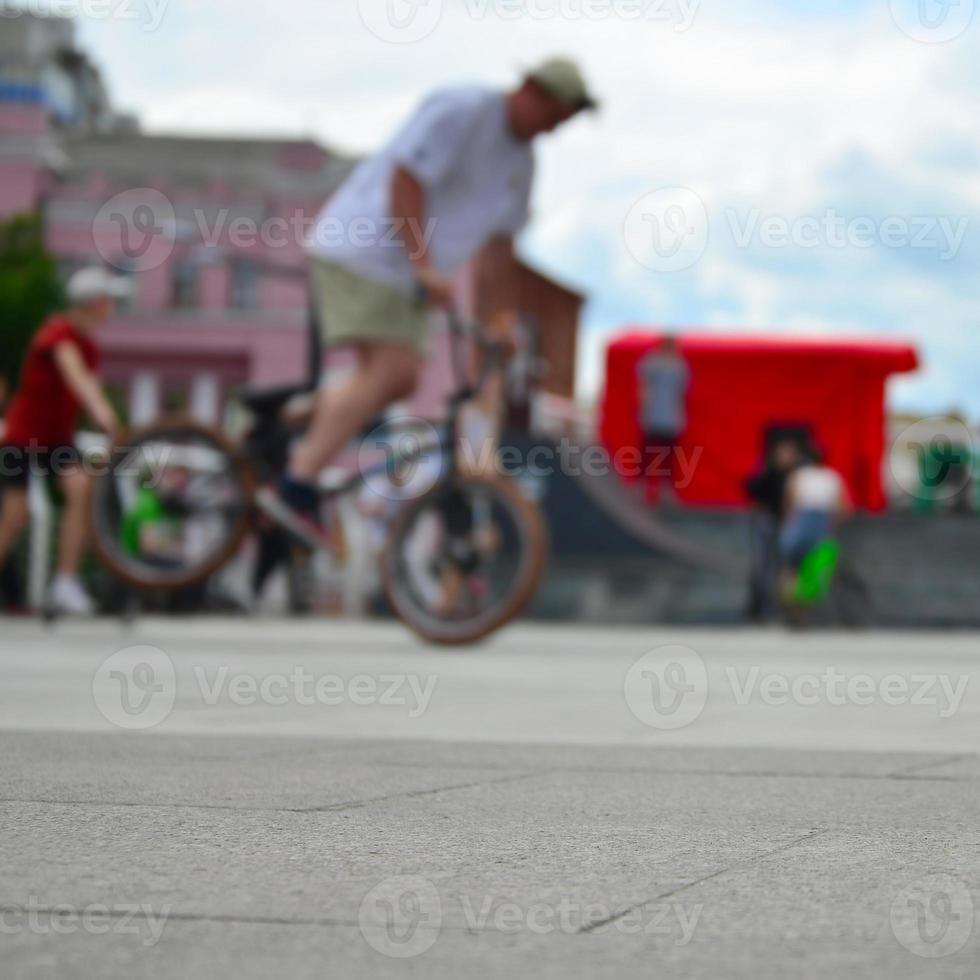 Defocused image of a lot of people with bmx bikes. Meeting of fans of extreme sports photo