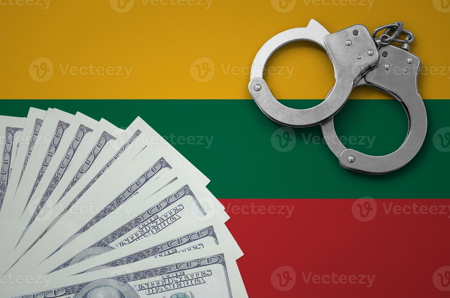 Lithuania flag  with handcuffs and a bundle of dollars. The concept of illegal banking operations in US currency photo
