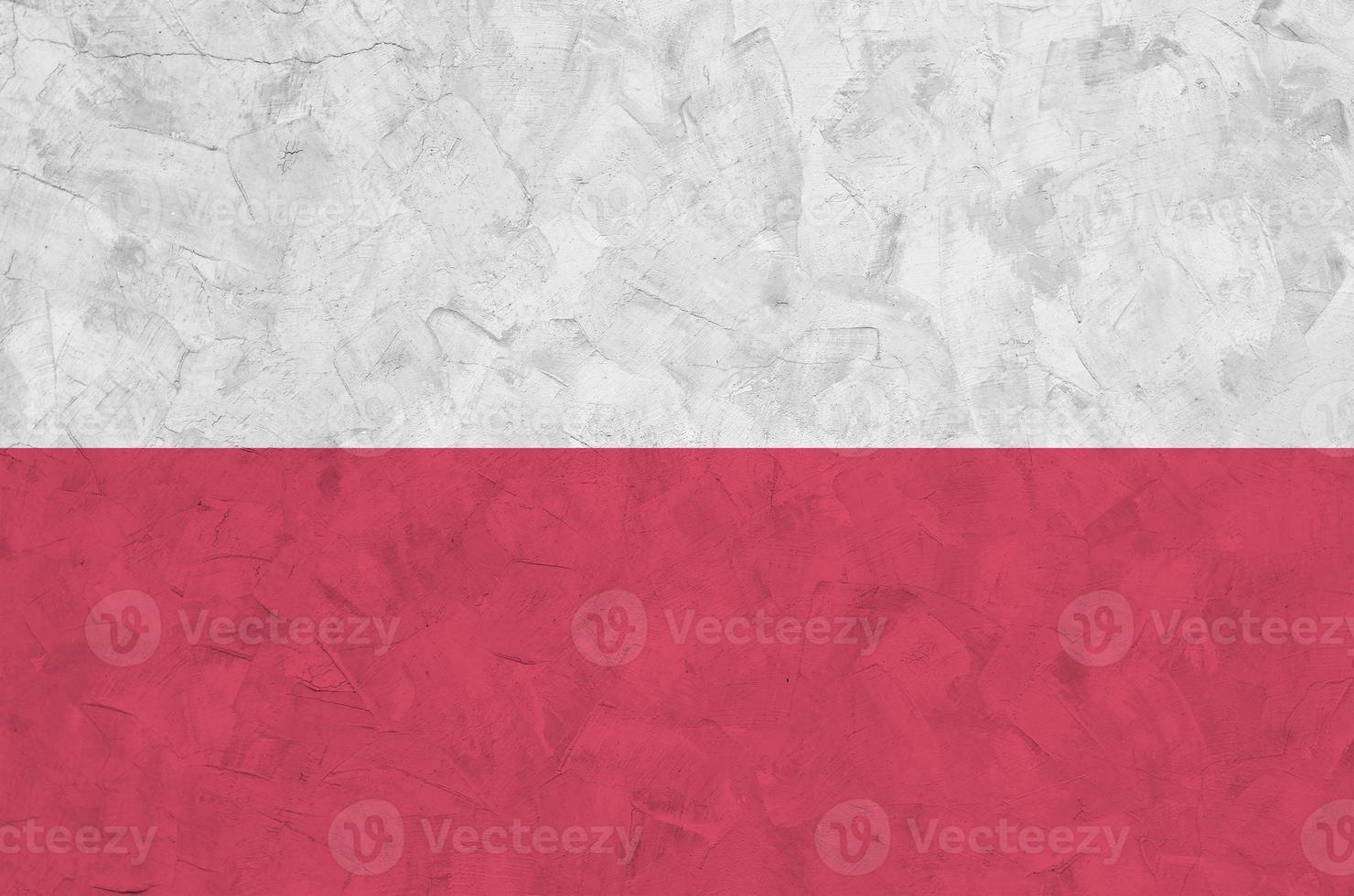 Poland flag depicted in bright paint colors on old relief plastering wall. Textured banner on rough background photo