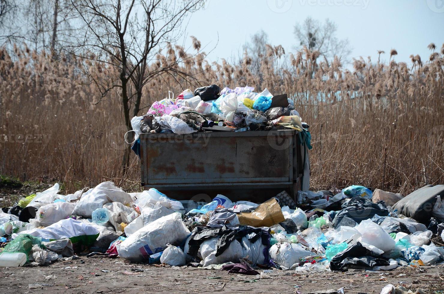 Garbage can is packed with garbage and waste. Untimely removal of garbage in populated areas photo