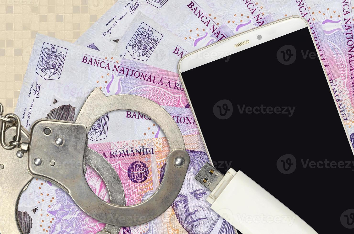 50000 Romanian leu bills and smartphone with police handcuffs. Concept of hackers phishing attacks, illegal scam or malware soft distribution photo