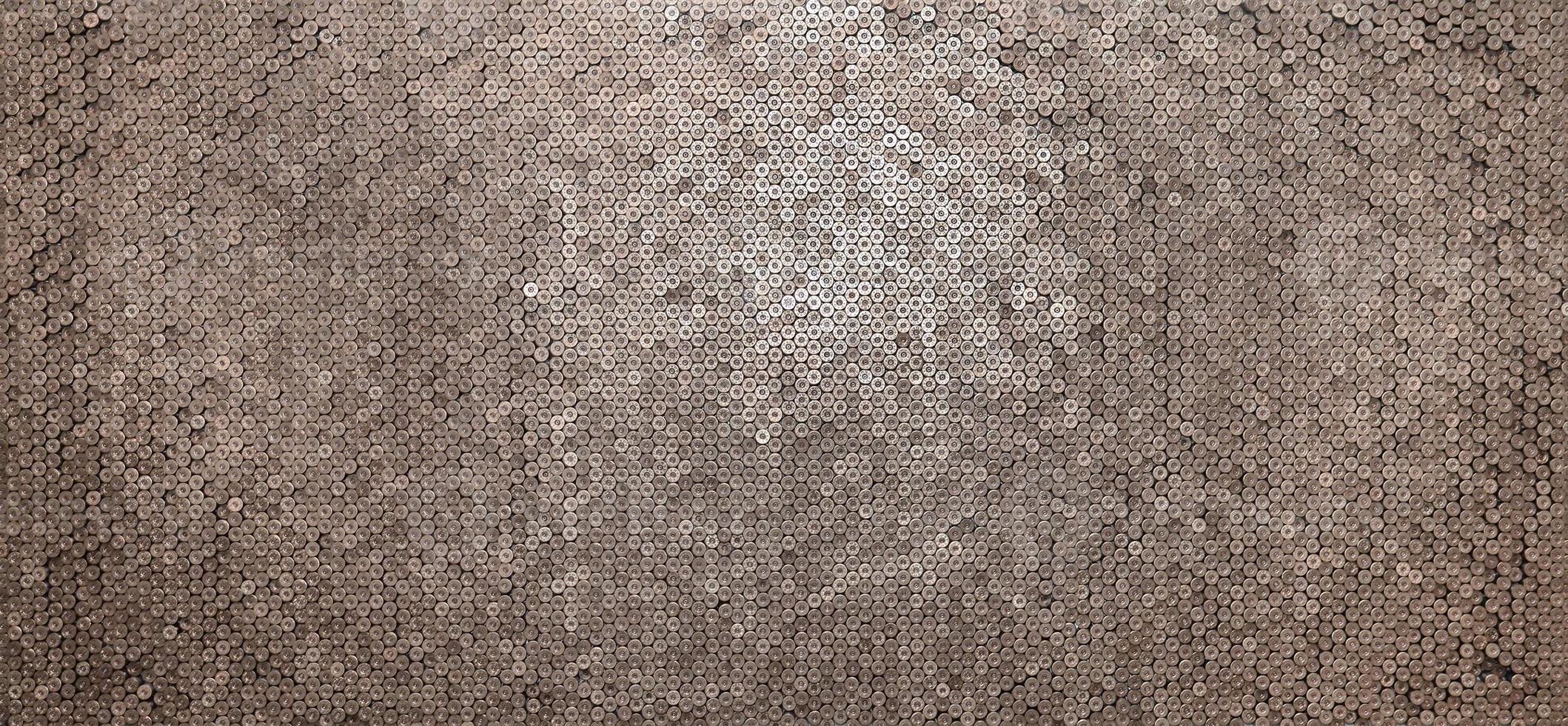 Pattern of 12 gauge cartridges for shotgun bullets. Shells for hunting rifle close up. Backdrop for shooting range or ammunition trade concepts photo