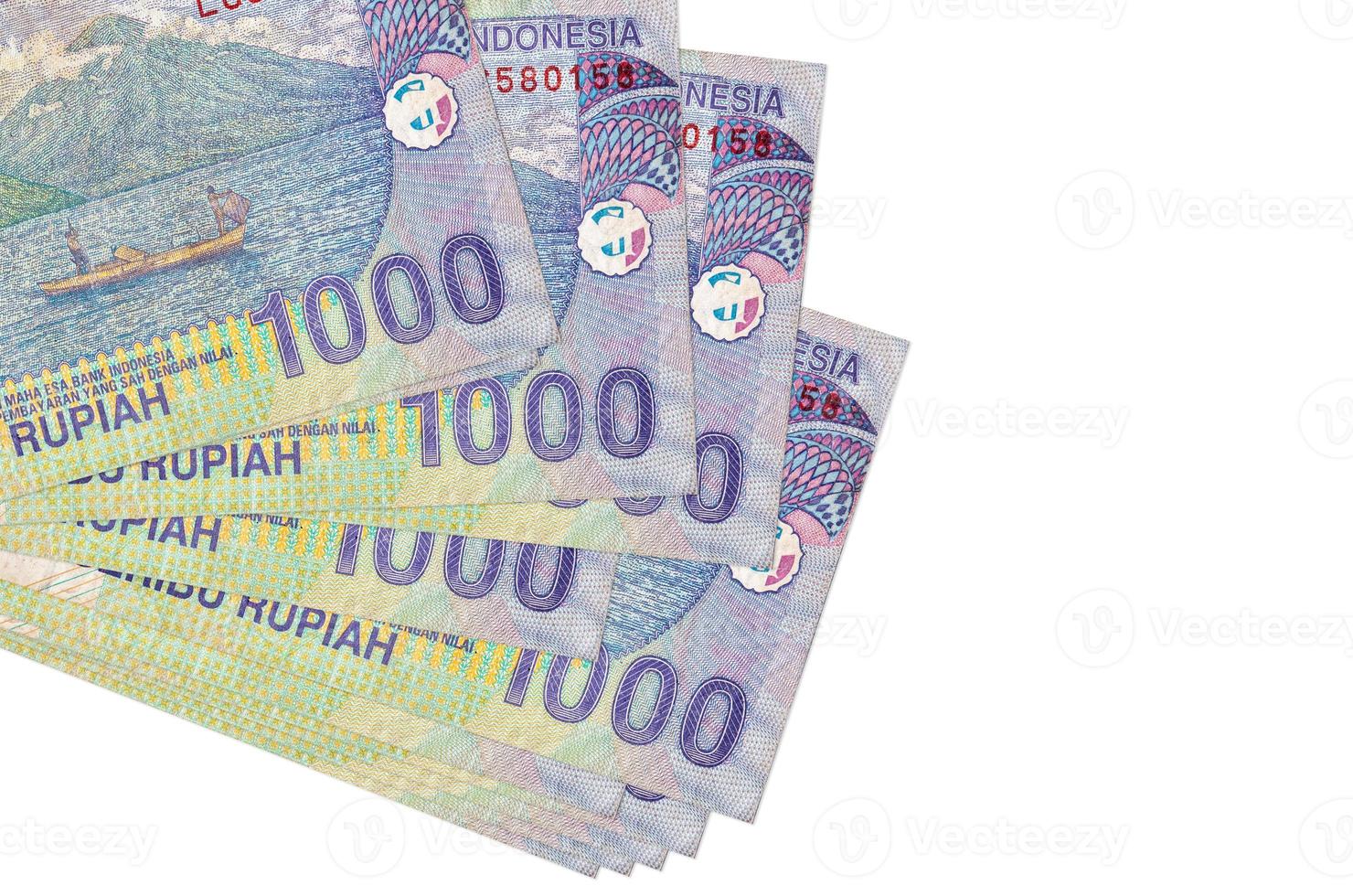 1000 Indonesian rupiah bills lies in small bunch or pack isolated on white. Mockup with copy space. Business and currency exchange photo