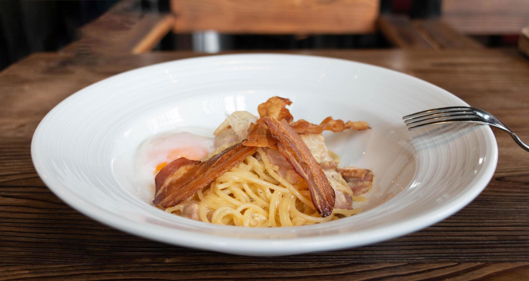 homemade spaghetti carbonara with bacon and egg photo
