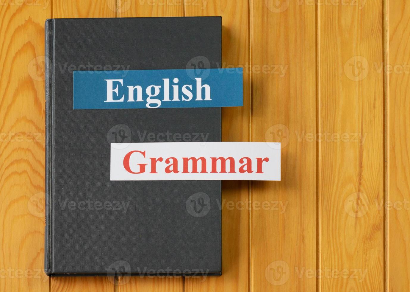 English cards on textbook on wooden board photo