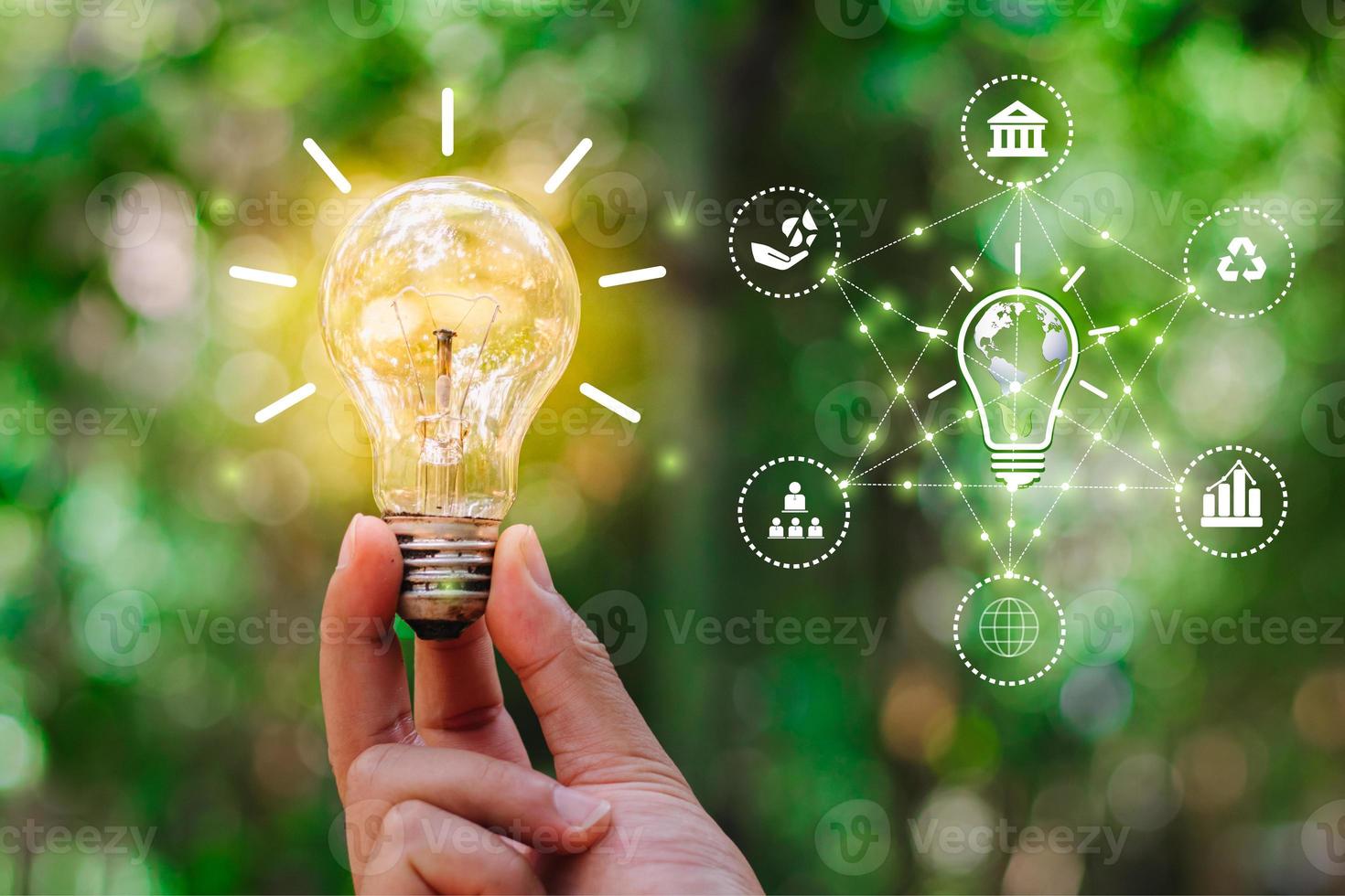 Hand holding light bulb against nature for environmental, social, and governance in sustainable and ethical business on the Network connection, ESG icon concept. photo