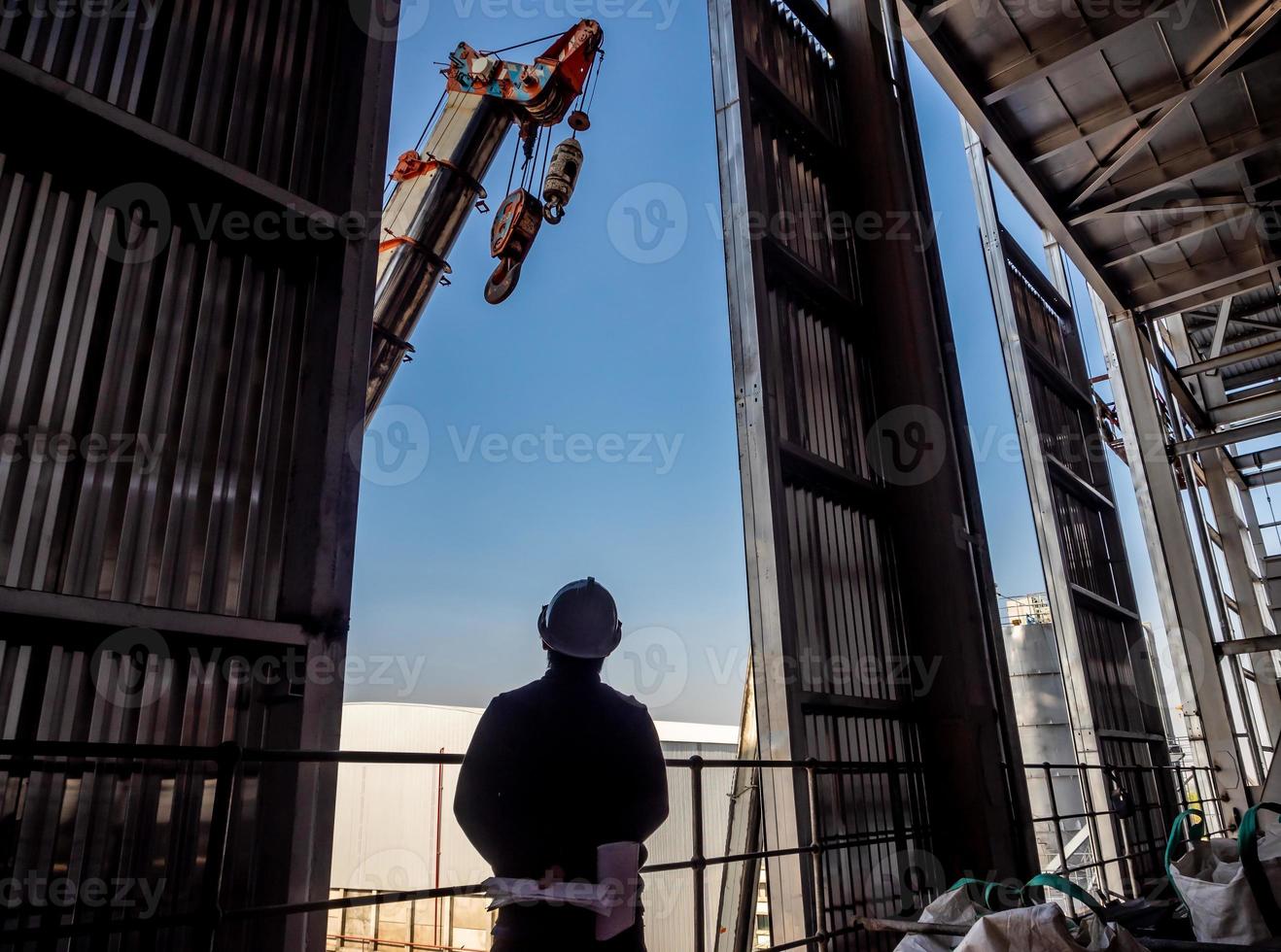 Hoist of crane at the window of industrial plant photo