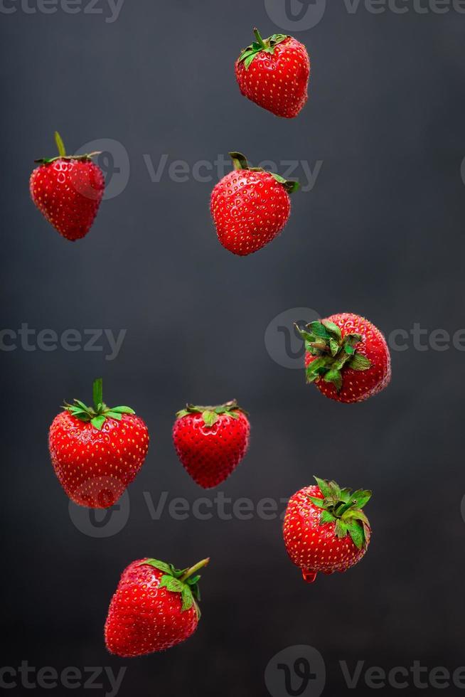 Strawberry berry levitating on a black background photo